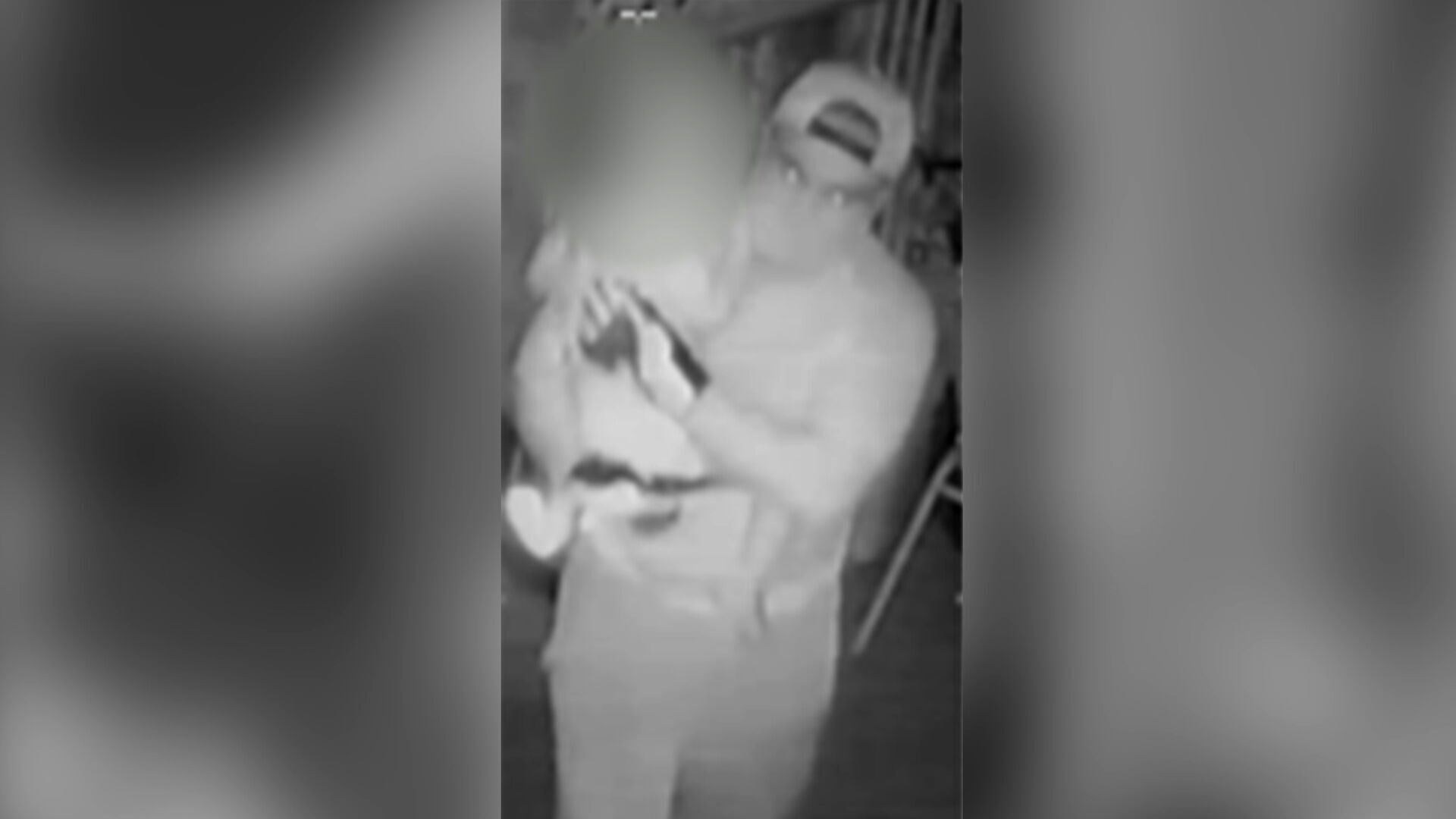 The intruder can be seen carrying the toddler from his Brisbane home.