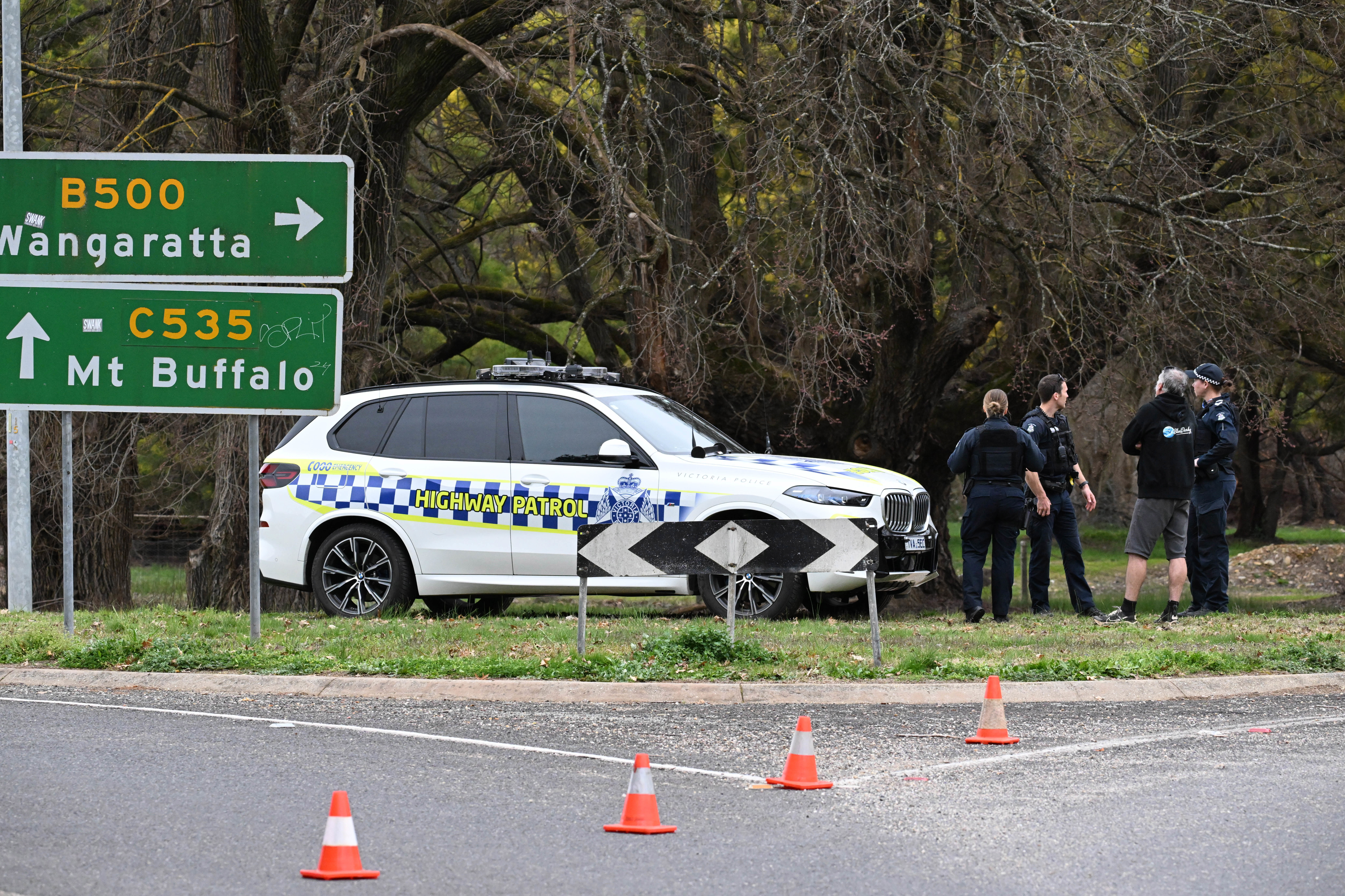Police at the scene in Porepunkah, where two officers were shot dead and another injured while serving a warrant.