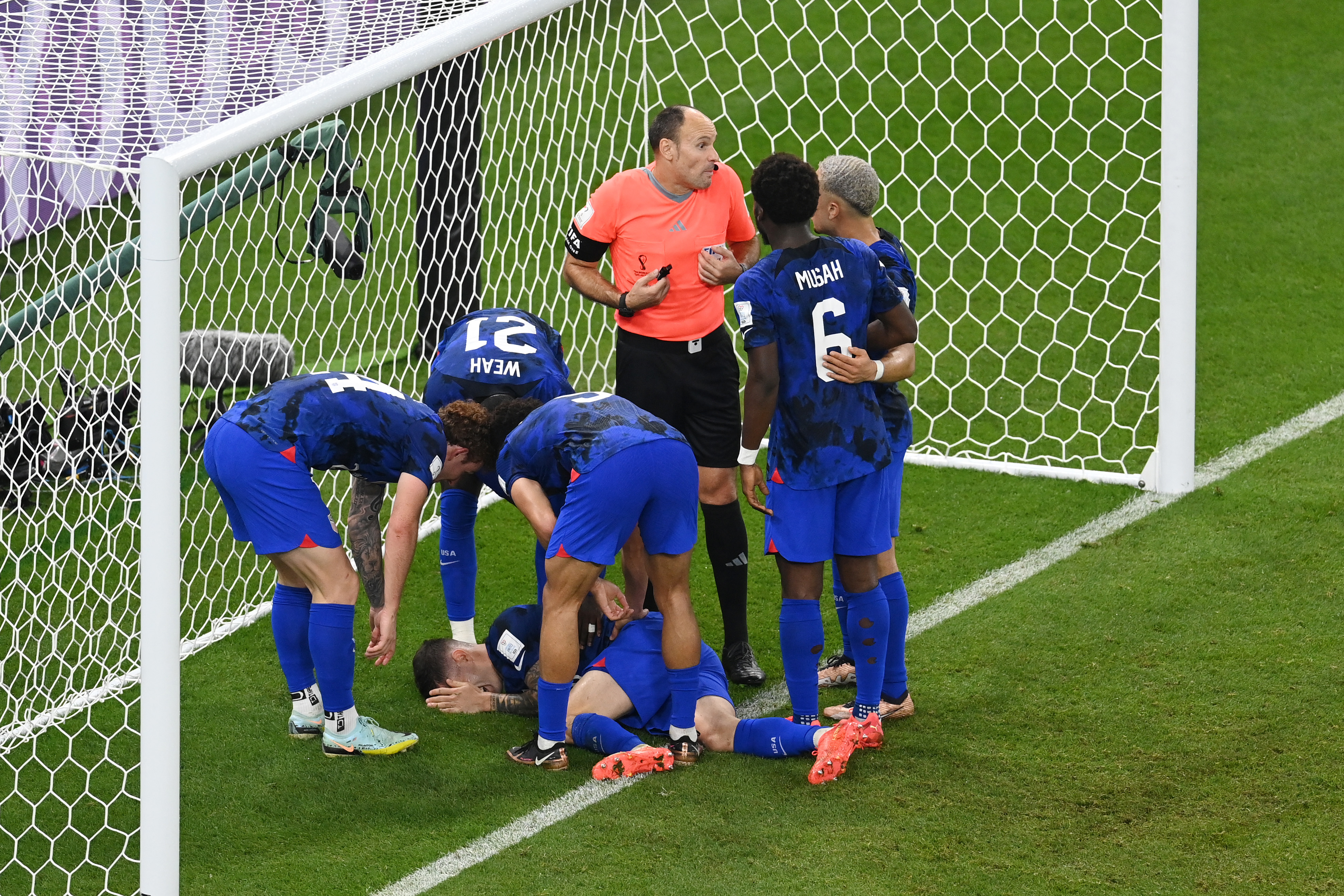 DOHA, QATAR - NOVEMBER 29: Christian Pulisic of United States receives medical treatment after scoring their sides first goal during the FIFA World Cup Qatar 2022 Group B match between IR Iran and USA at Al Thumama Stadium on November 29, 2022 in Doha, Qatar. (Photo by Claudio Villa/Getty Images)