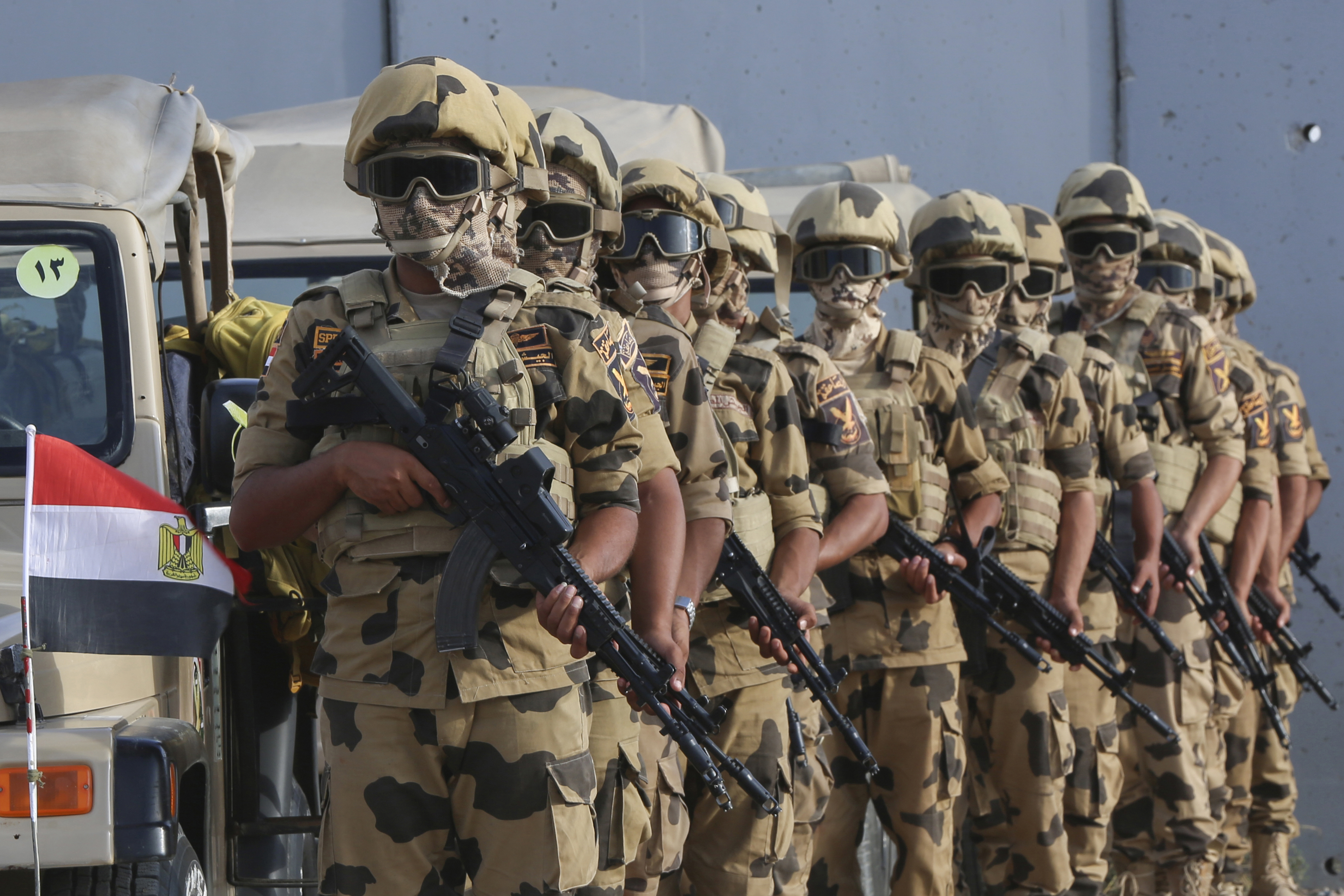 Military personnel stand alert at the Rafah border crossing