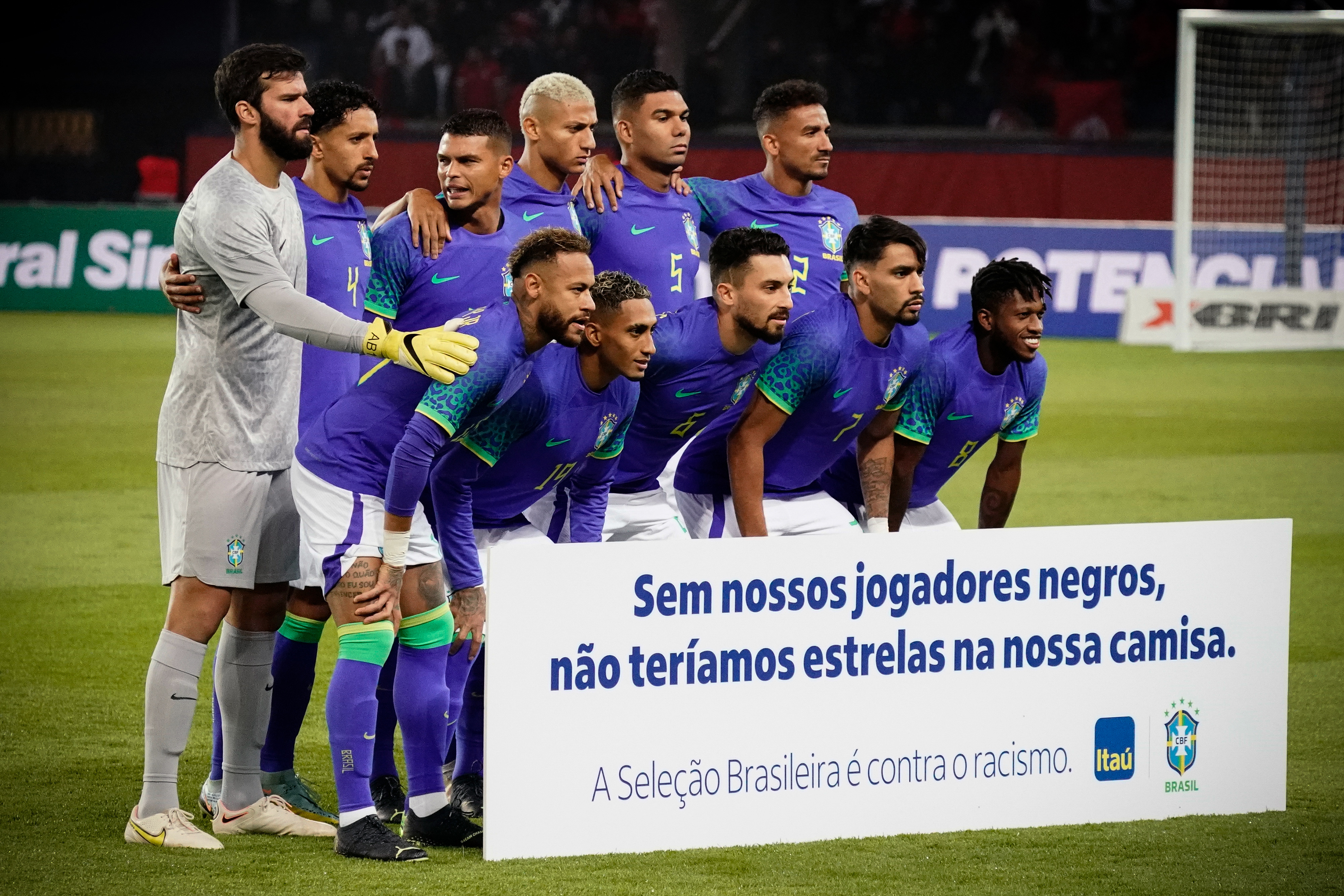 Brazil players pose with an anti-racism banner.