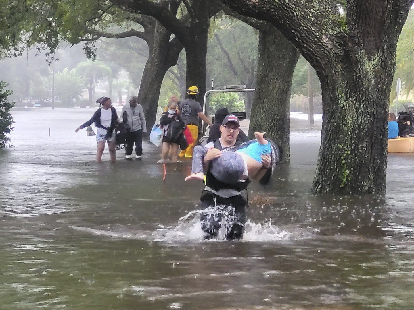 This photo provided by Naples Fire-Rescue Department crews help rescue a stranded motorist from flooding caused by Hurricane Ian on Wednesday, Sept. 28, 2022.