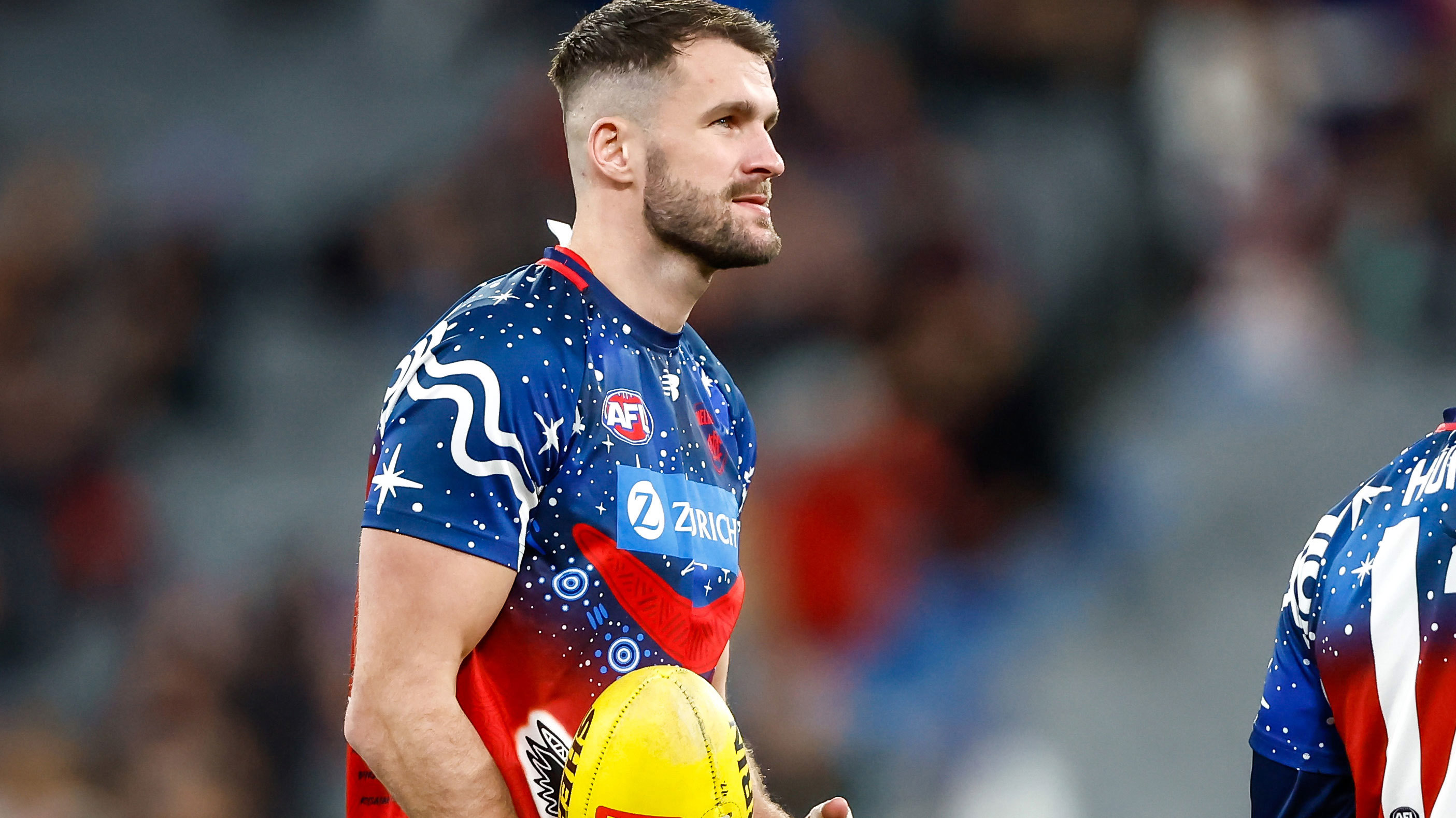 Joel Smith of the Demons warms up before their round 18 match against the Brisbane Lions. 