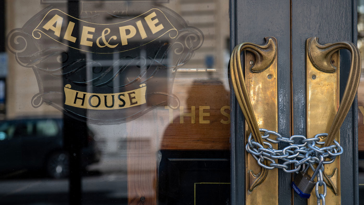 A lock and chain is in place across an entrance to a closed pub after further lockdown restrictions have been eased on June 23, 2020 in London, England
