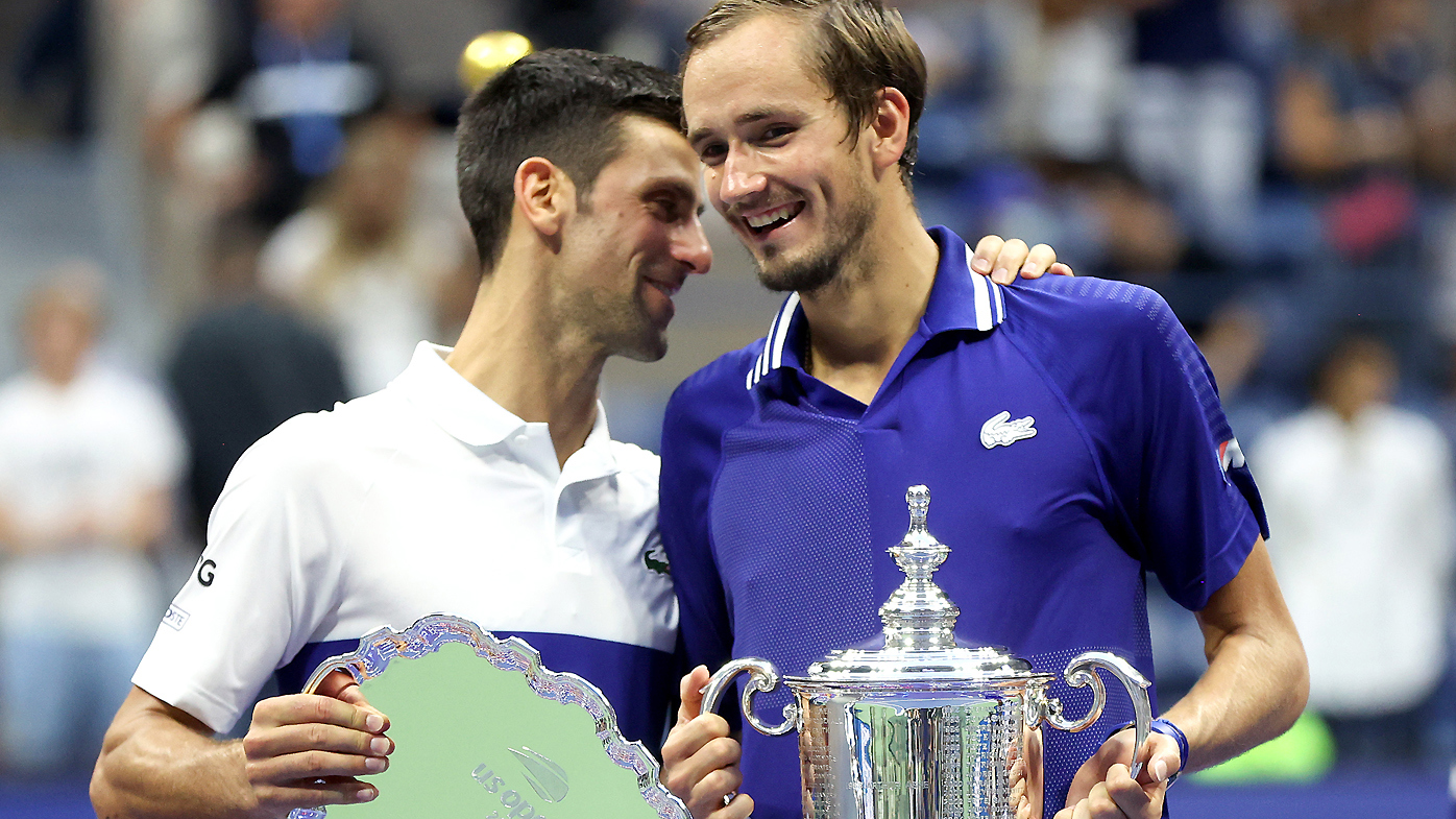 Daniil Medvedev and Novak Djokovic share a laugh during the trophy presentation