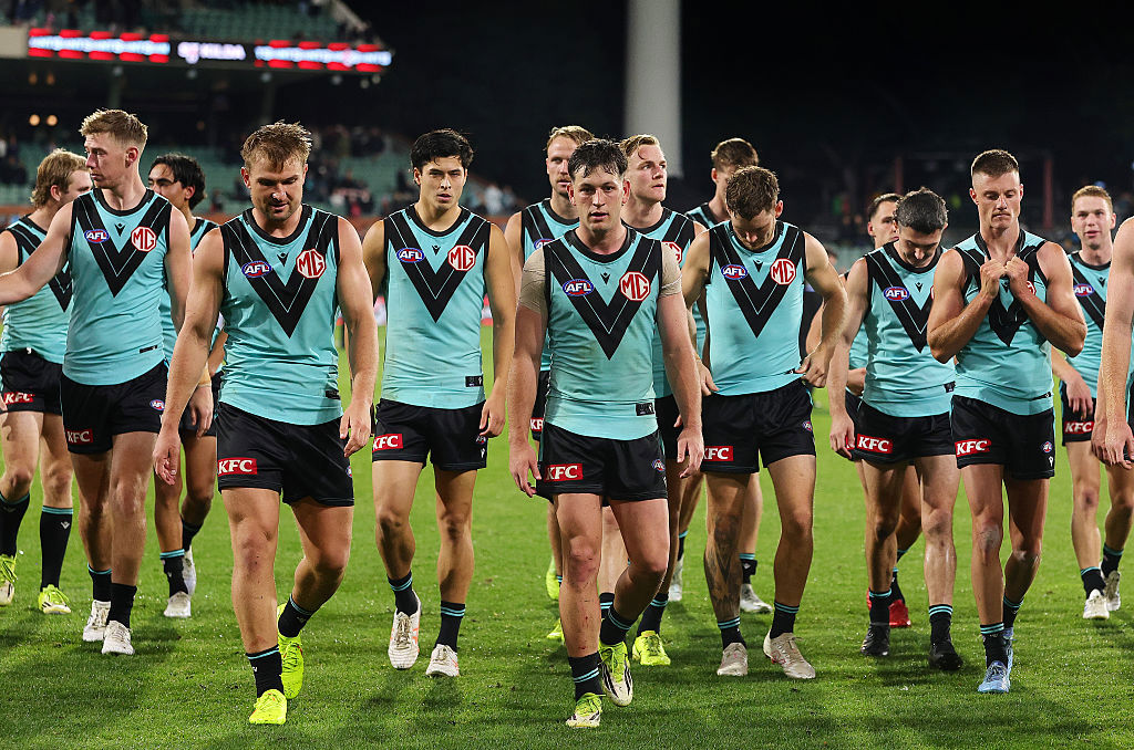 Zak Butters leads the team off after the loss.