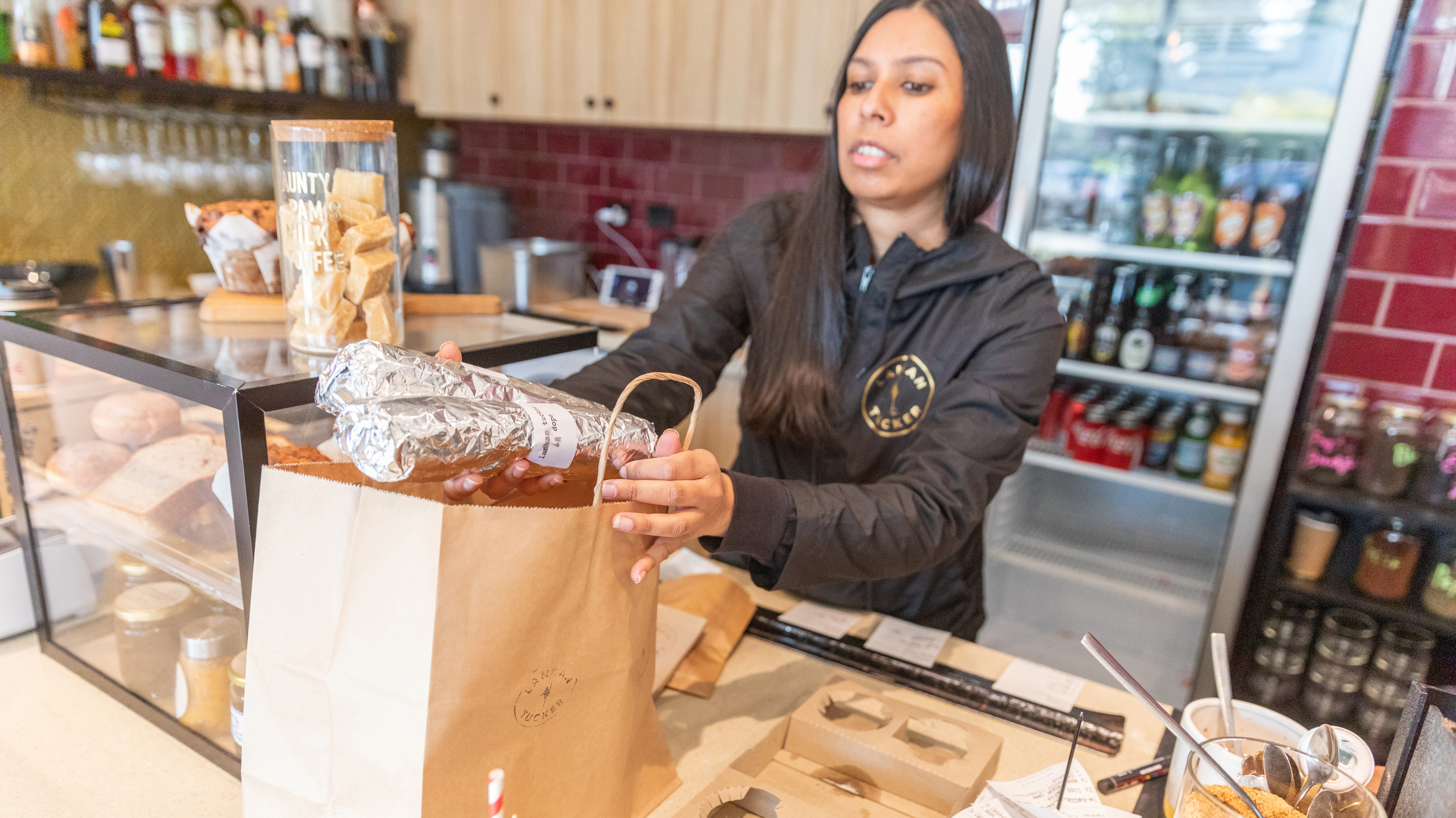Nerissa Jayasingha owner of cafe Lankan Tucker packing a take away order on July 09, 2020 in Melbourne, Australia. 
