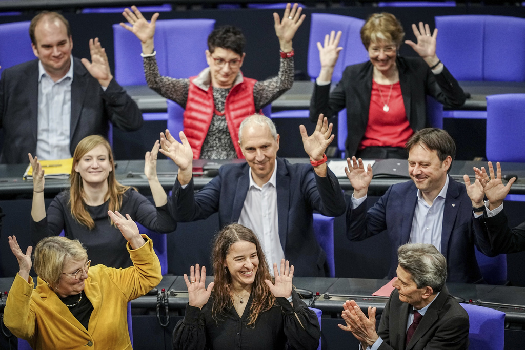 Lawmaker Heike Heubach, front center, the first deaf member of the Bundestag, sits between members of the faction of the German Social Democrats (SPD) at the start of a meeting of the German federal parliament, Bundestag, at the Reichstag building in Berlin, Germany, Thursday, March 21, 2024. 