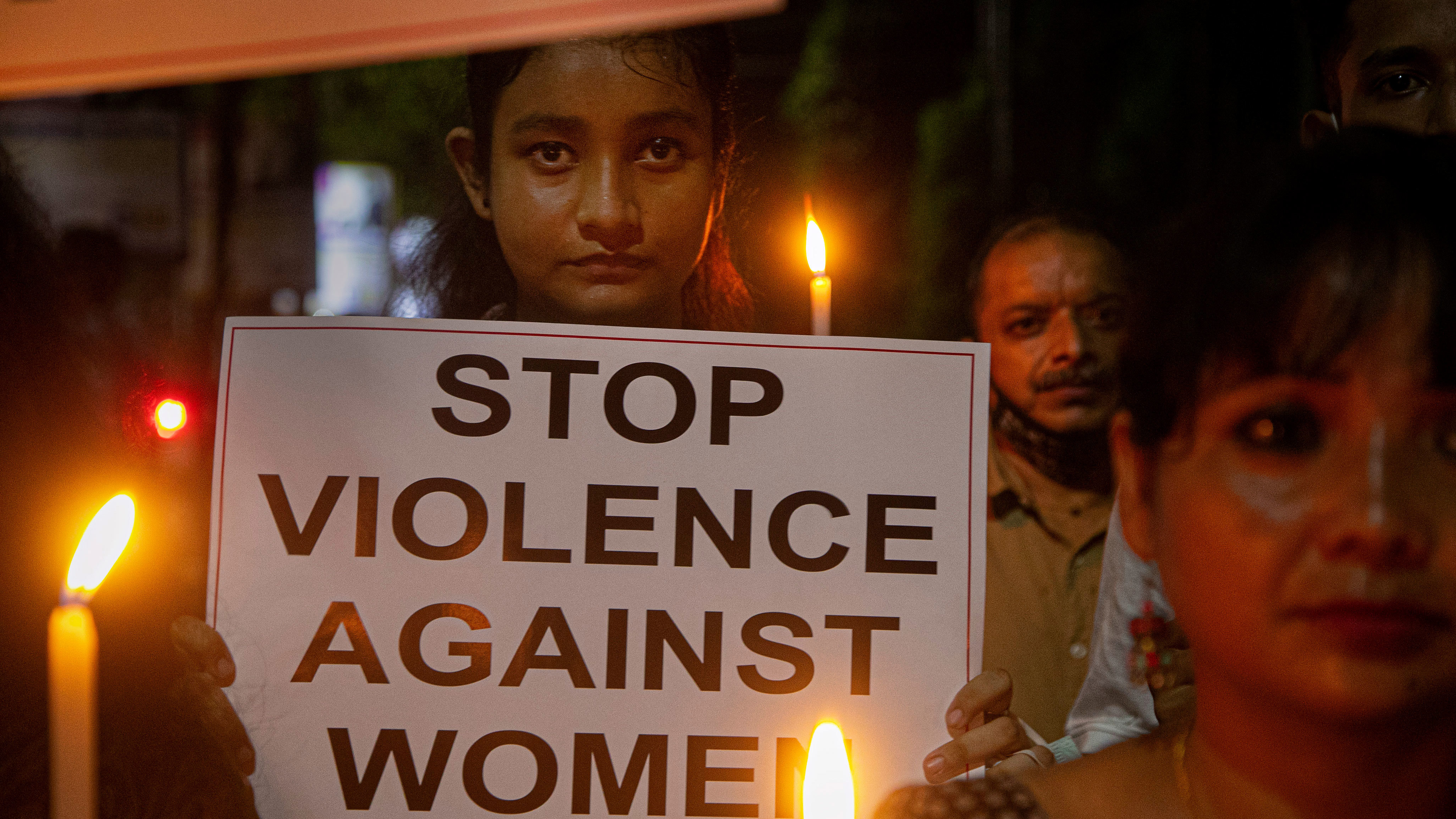 Indian women hold placards protesting against the alleged gang rape and killing of a Dalit woman in Uttar Pradesh state, in Gauhati, India, in October 2020.