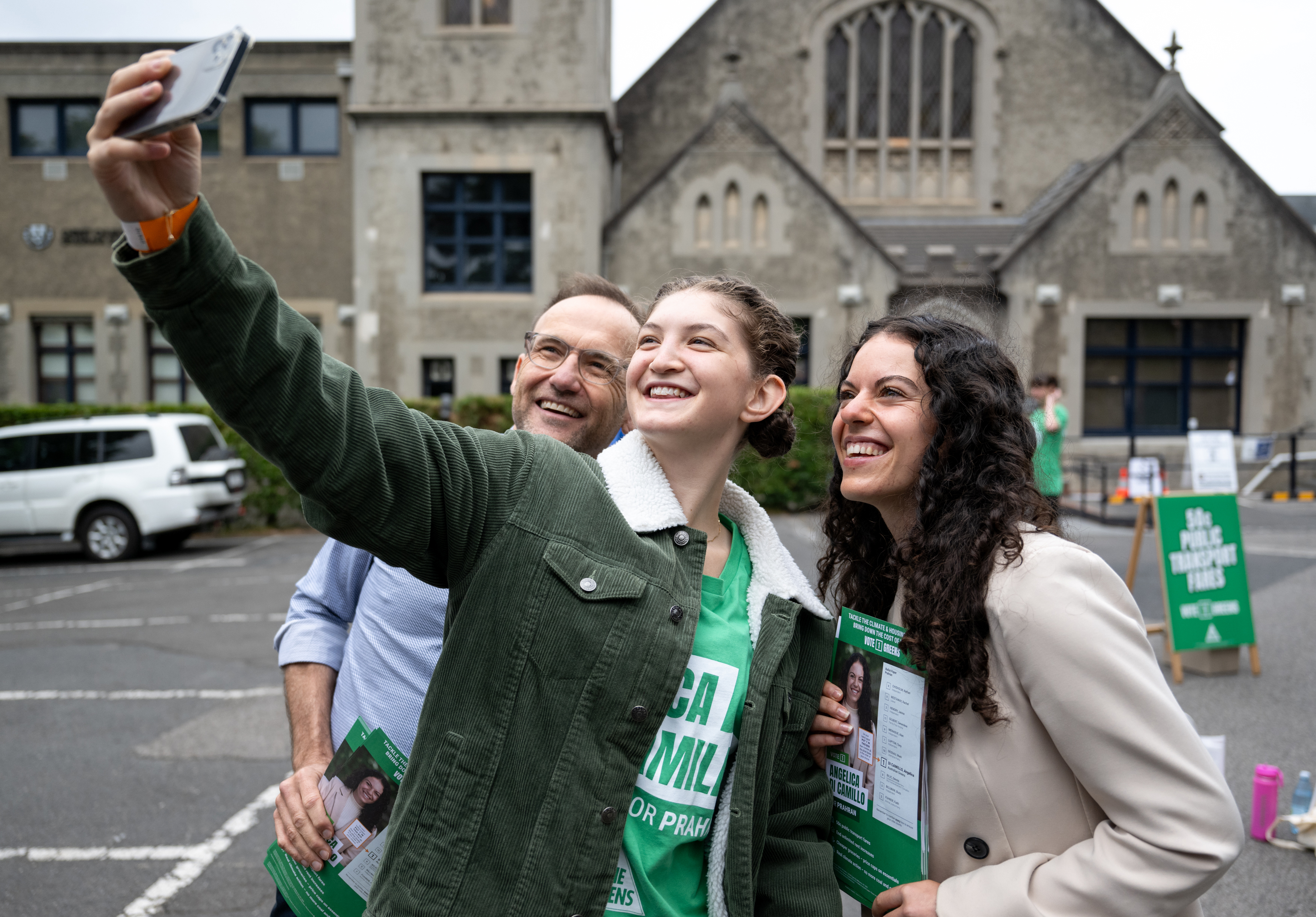 Australian Greens leader Adam Bandt and Greens candidate Angelica Di Camillo having a selfie taken by a greens supporter at the Christ Church Grammar School AEC polling centre for the Prahran byelection, Melbourne. The Age. Picture: Penny Stephens. Saturday 8th February 2025