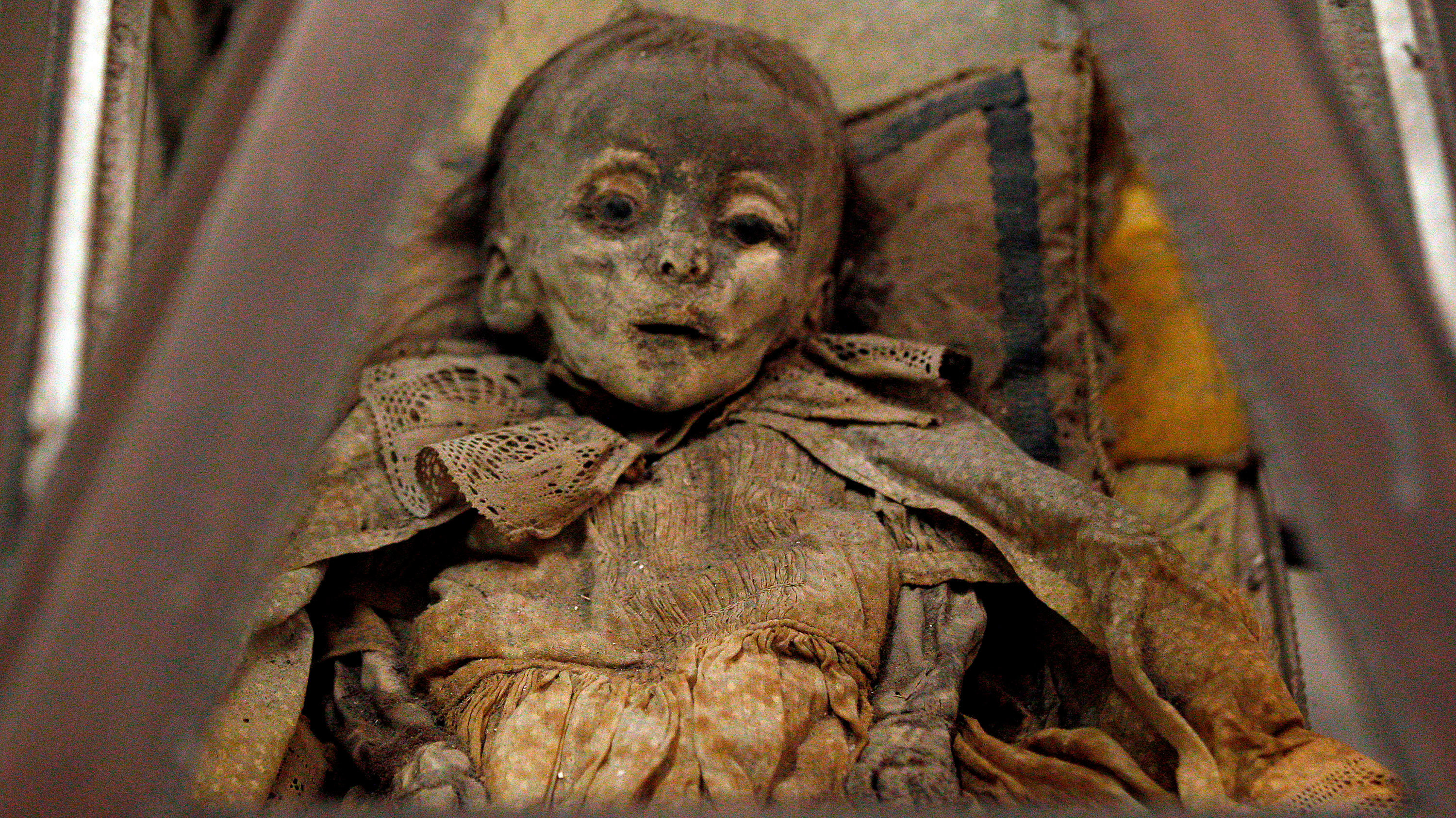 Fully clothed human remains of a child, representing some of the world's best-preserved bodies, are displayed at the Capuchin Catacombs in Palermo, southern Italy, January 31, 2011. The catacombs, frequented by tourists, contain thousands of remains of clerics, nobility, and families of local citizens dating from about the mid-16th century, well preserved due to an ancient and highly effective embalming process. Originally intended for friars of the Capuchin monastery, the catacombs evolved, wit