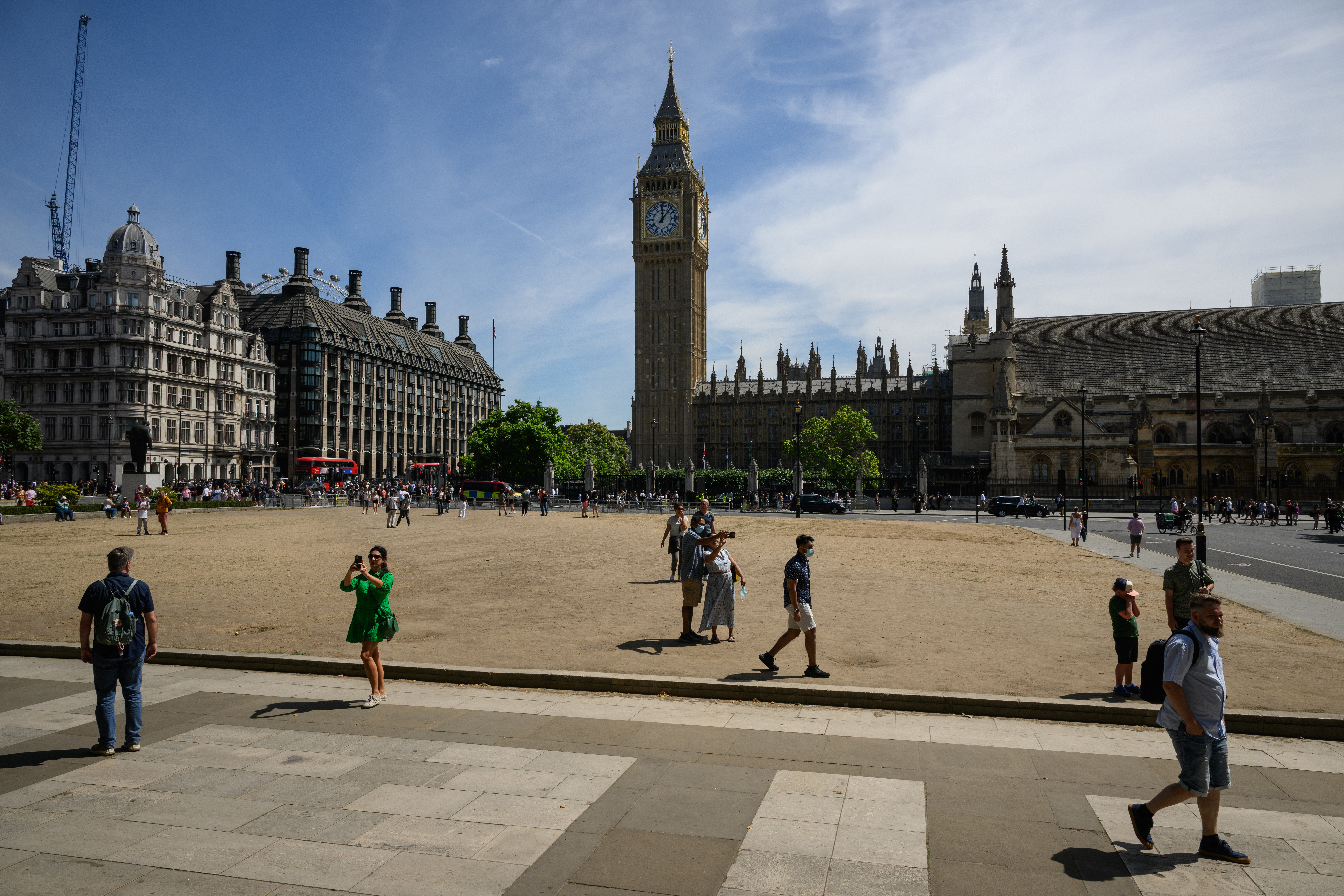 Tourists walk on the sun-baked Parliament Square on July 14, 2022 in London, England. 