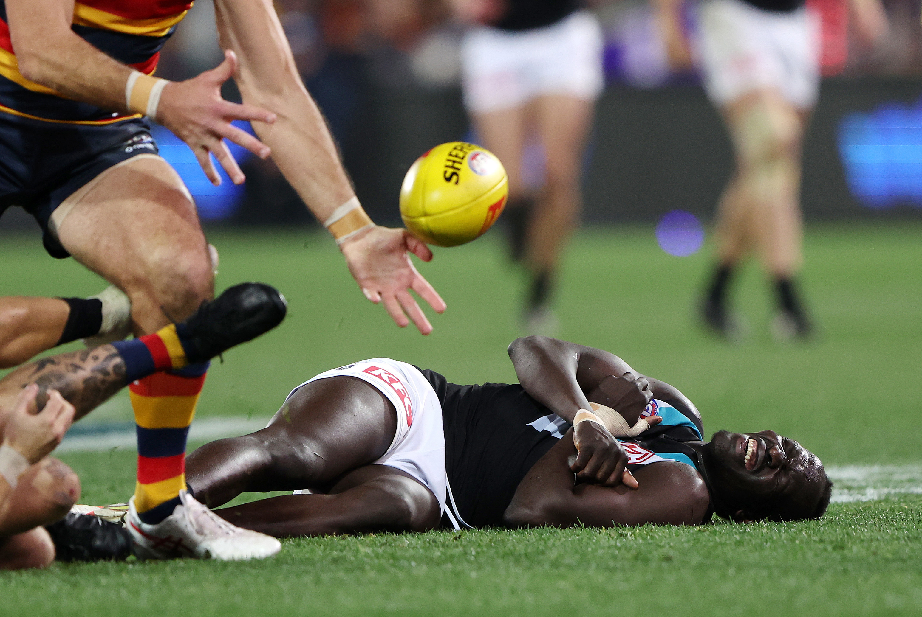 Aliir Aliir of the Power down after a collision with Lachie Jones of the Power during the 2023 AFL Round 20 match between the Adelaide Crows and the Port Adelaide Power at Adelaide Oval on July 29, 2023 in Adelaide, Australia. (Photo by Sarah Reed/AFL Photos via Getty Images)
