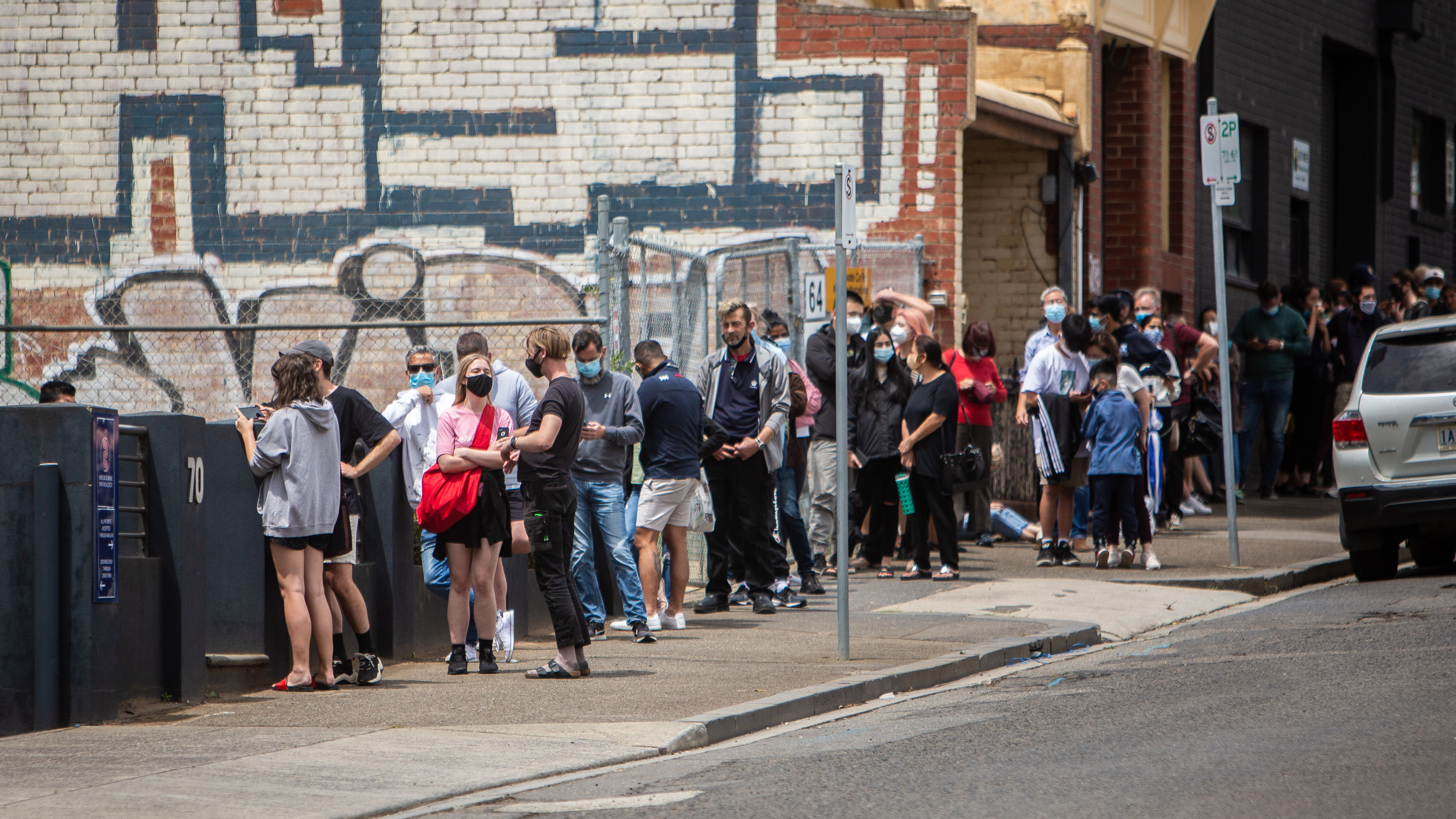 People queuing outside the COVID testing site on Alfred Street in North Melbourne.