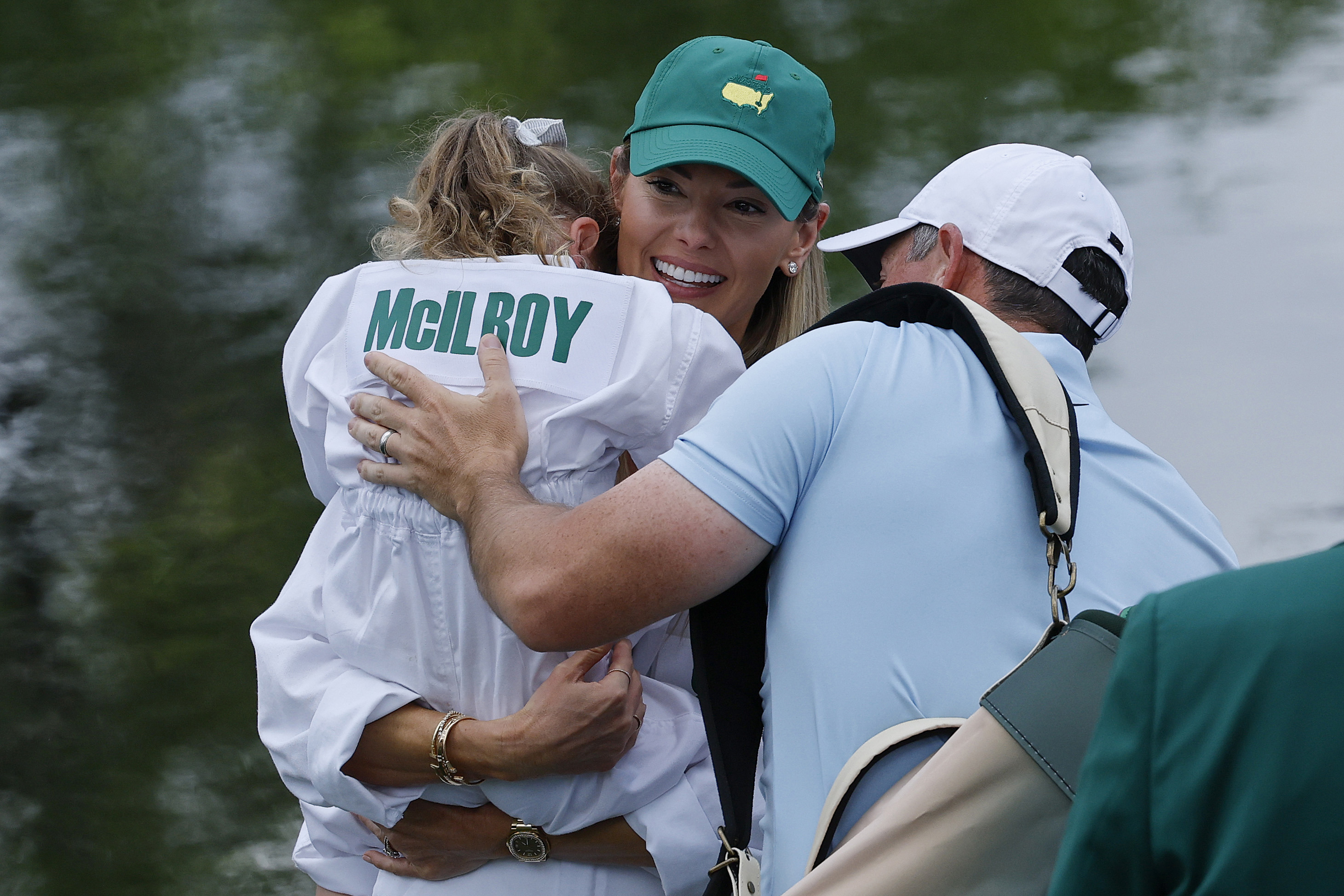 Rory McIlroy of Northern Ireland  and his wife, Erica Stoll embrace their daughter, Poppy McIlroy