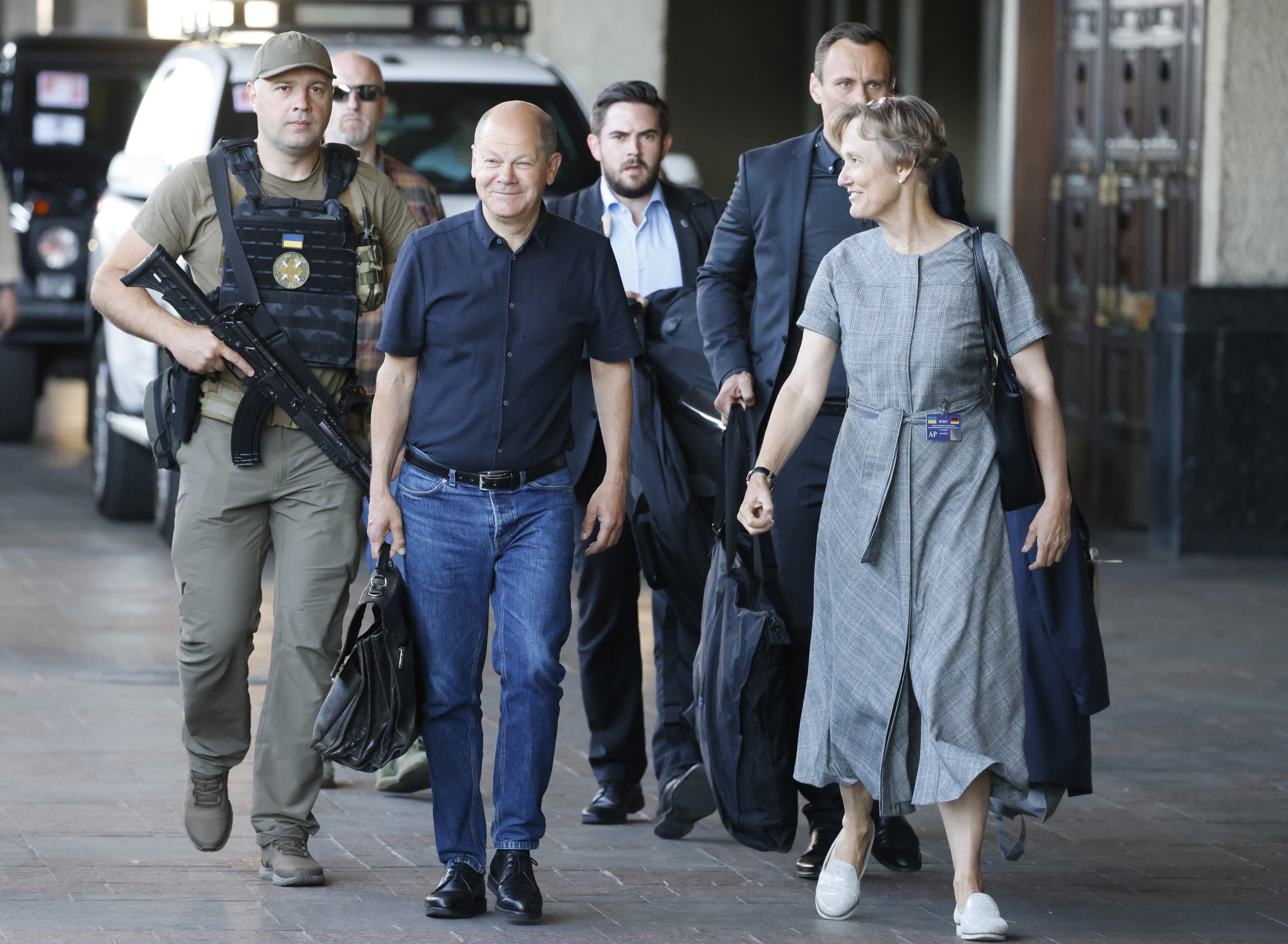 German Chancellor Olaf Scholz is escorted as he arrives at the Kyiv train station, Thursday, June 16, 2022. French President Emmanuel Macron Prime Minister Mario Draghi and German Chancellor Olaf Scholz are expected to meet with Ukraine's President Volodymyr Zelenskyy as they prepare for a key European Union leaders' summit in Brussels next week and a June 29-30 NATO summit in Madrid.(Ludovic Marin, Pool via AP)