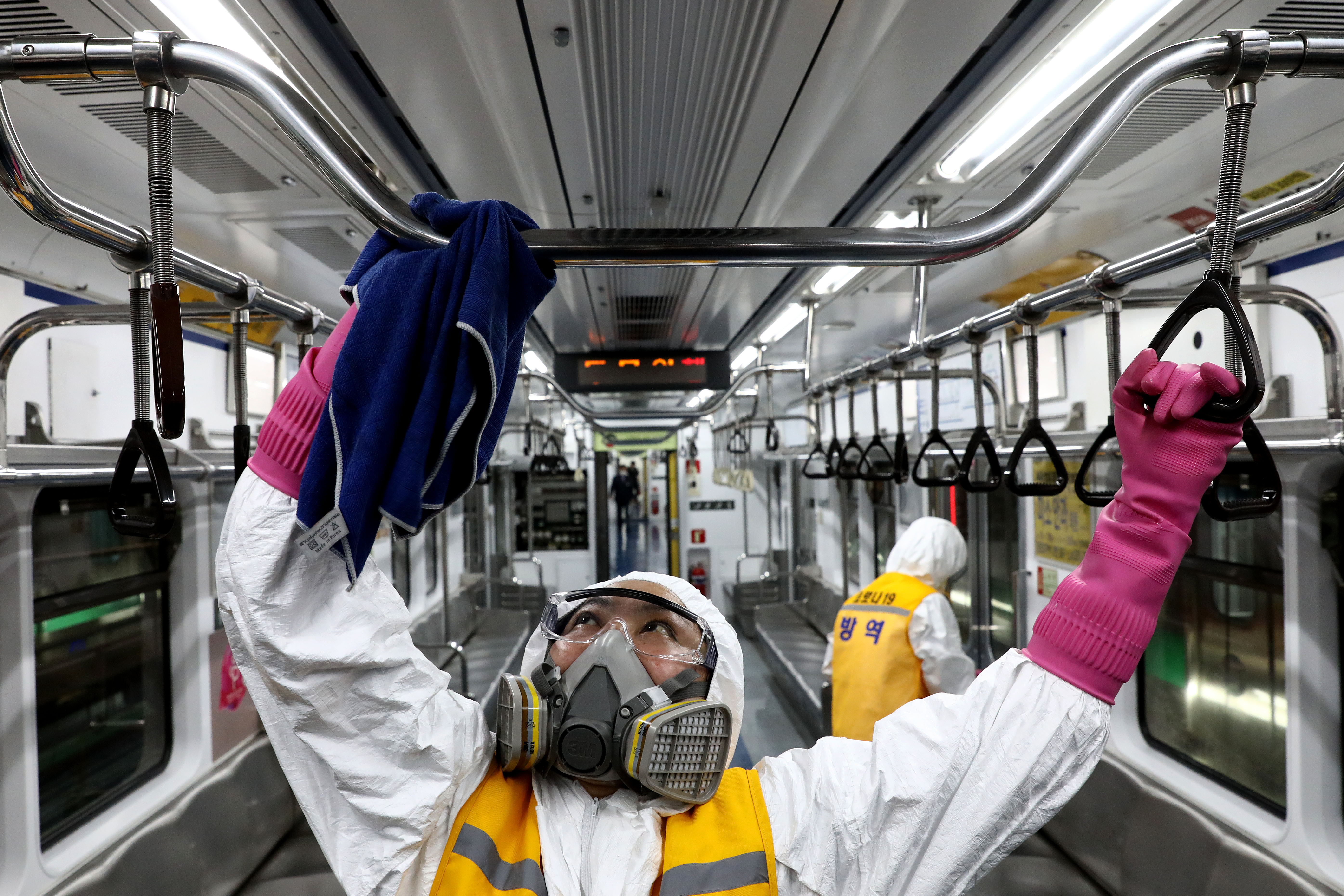 Disinfection workers wearing protective gear spray anti-septic solution against the coronavirus (COVID-19) in an subway at Seoul metro railway base. Pictue: Chung Sung-Jun