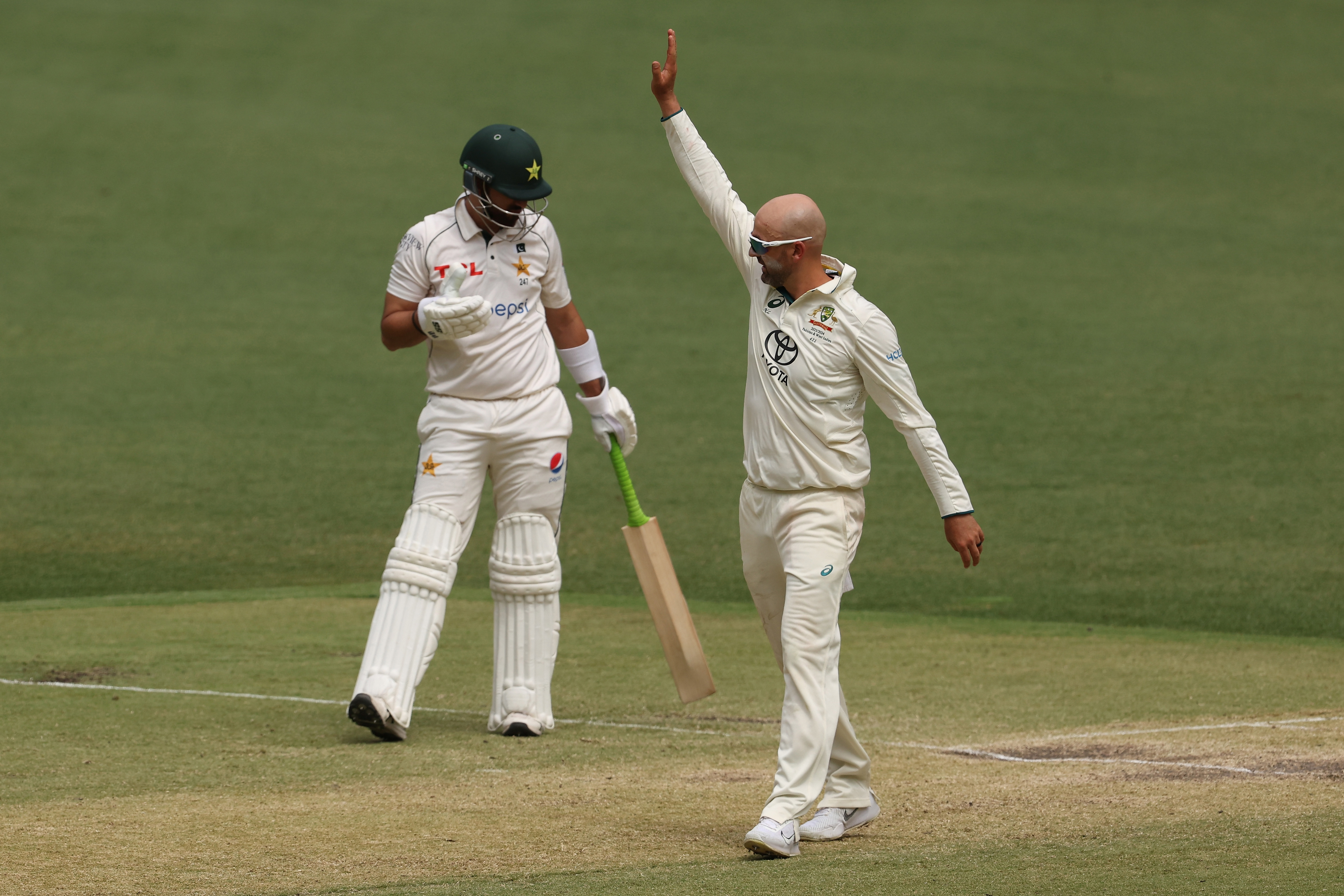 Nathan Lyon of Australia celebrates the wicket of Aamir Jamal.