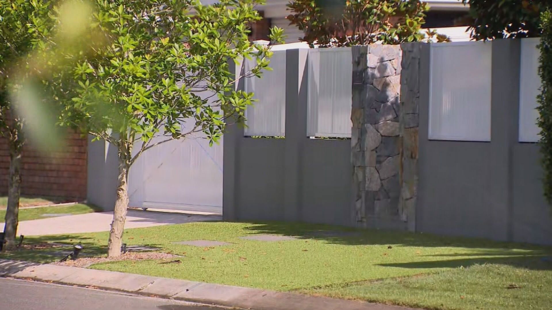 The synthetic grass covers the front and back yards but it is the footpath patch that has made her local council see red.