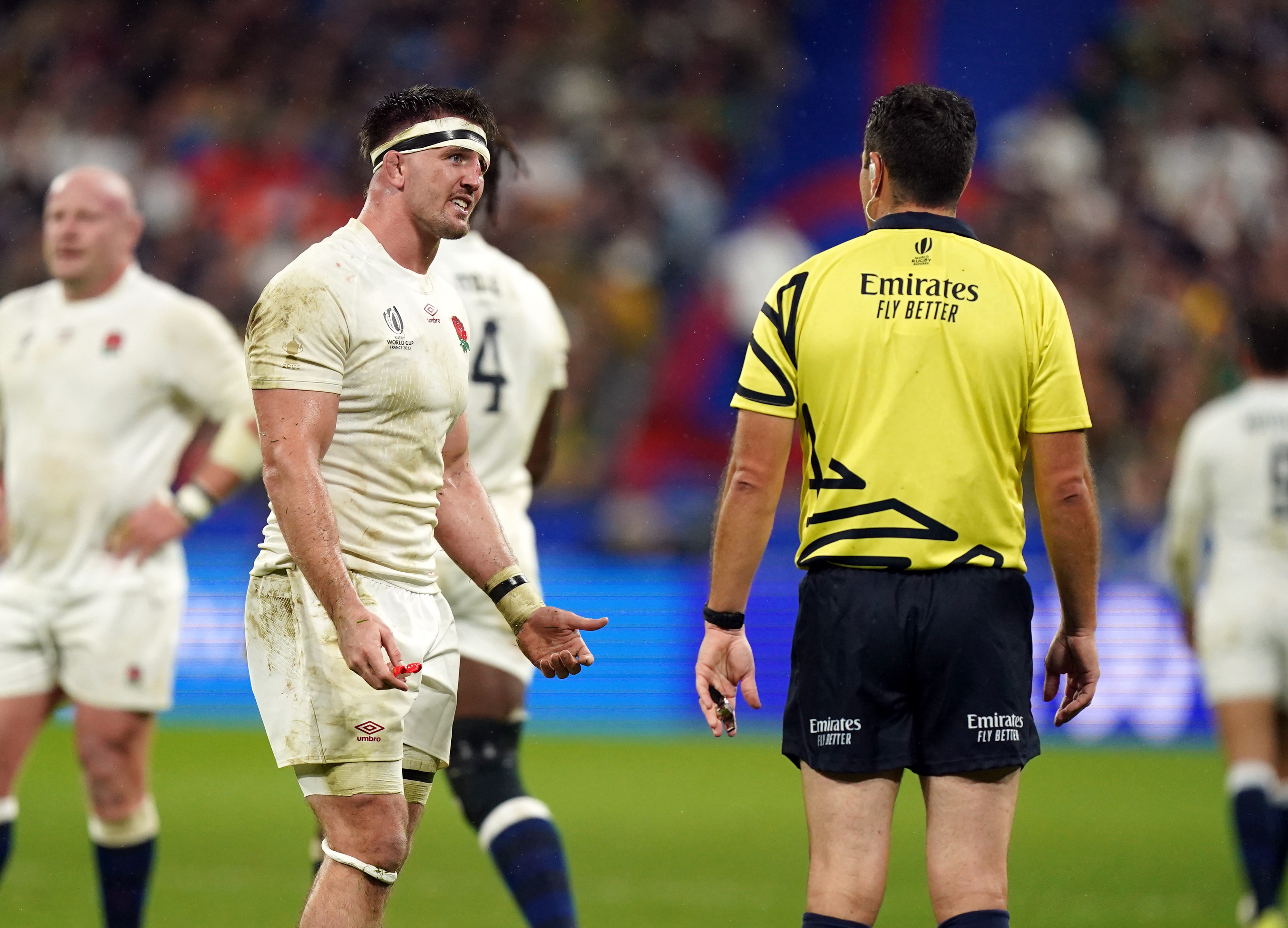 England's Tom Curry speaks to referee Ben O'Keeffe.