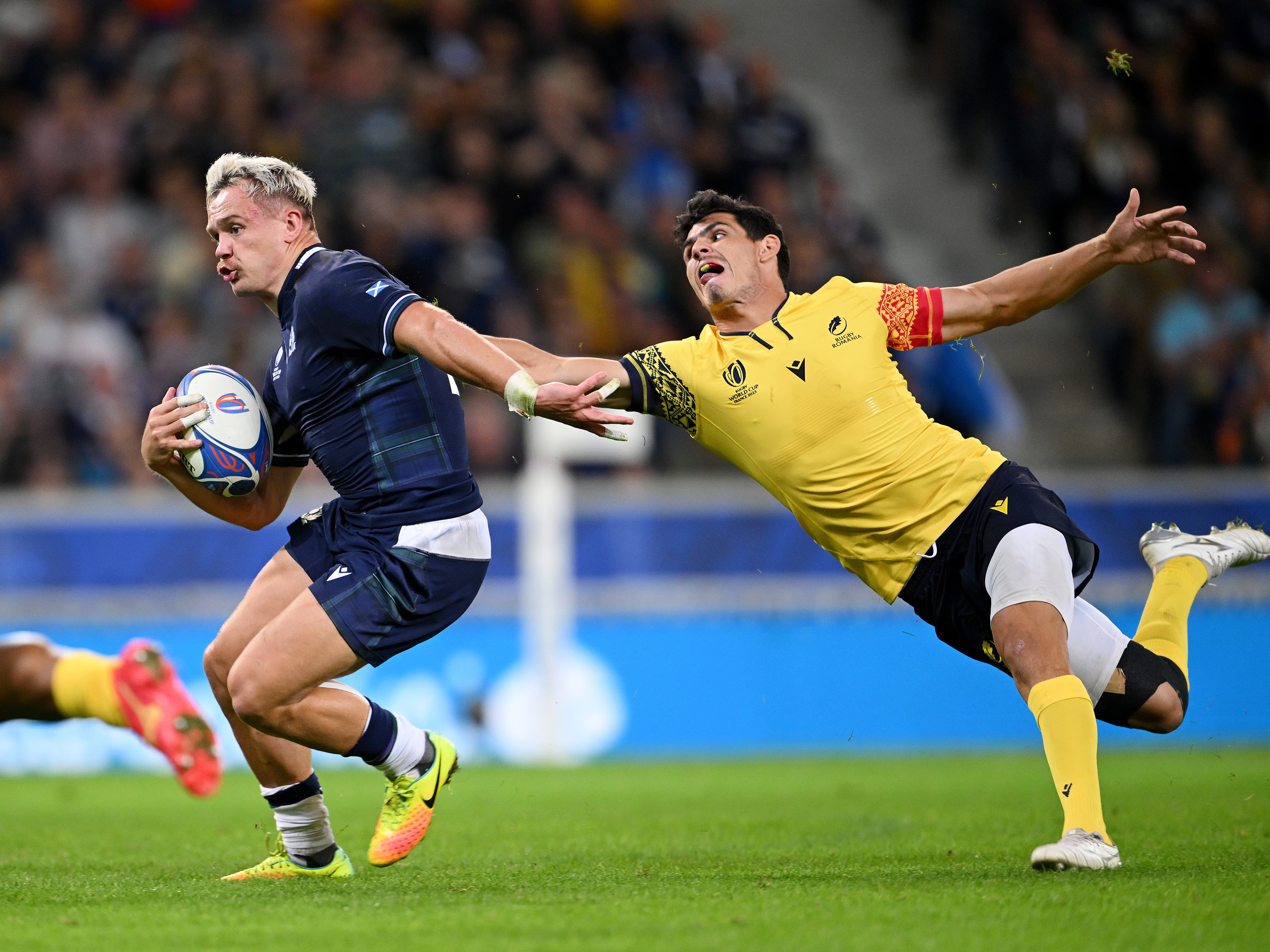 Darcy Graham of Scotland evades Marius Simionescu of Romania before scoring a try.
