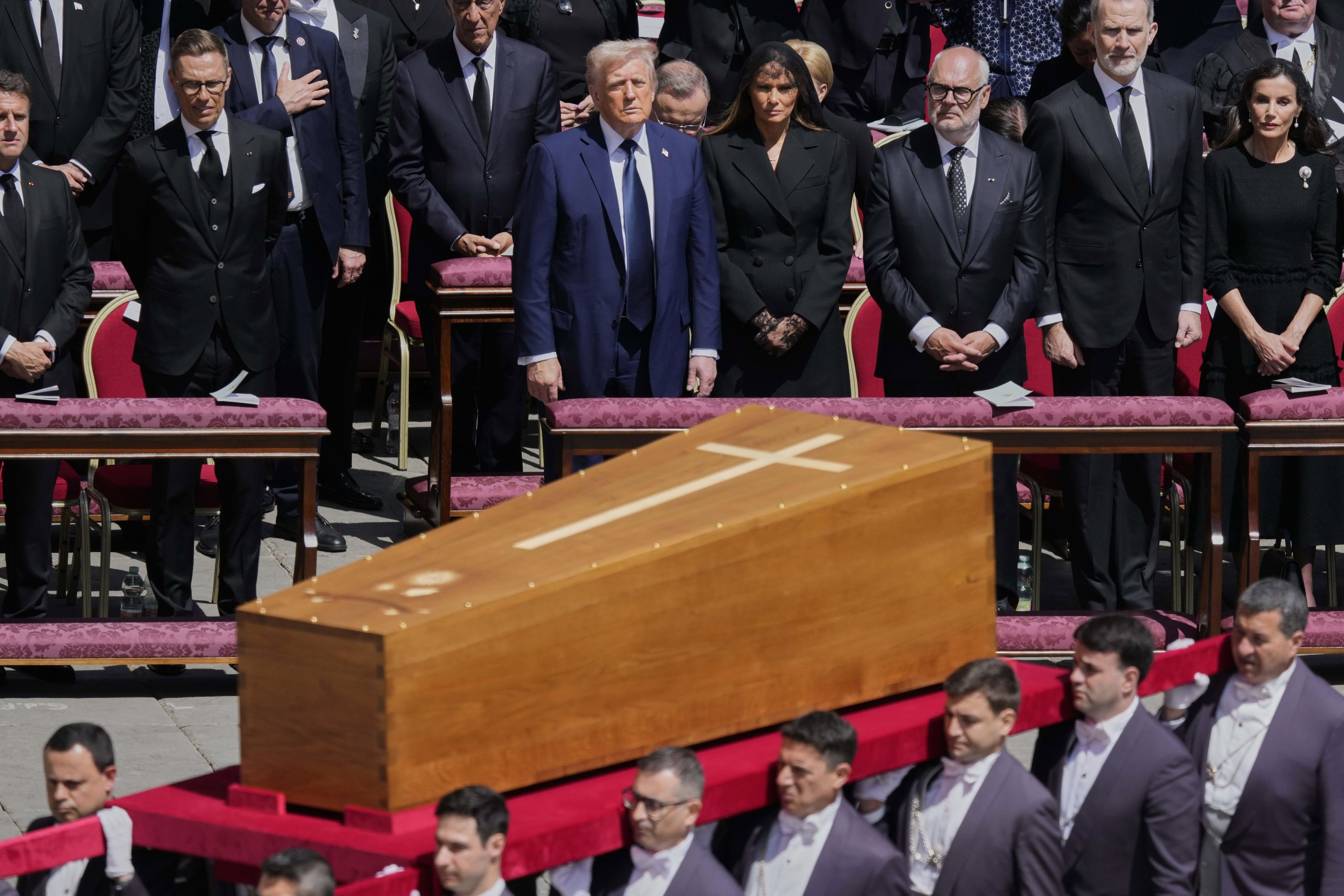 The coffin of Pope Francis is carried in front of dignitaries, including President Donald Trump during his funeral in St. Peter's Square at the Vatican, April 26, 2025.