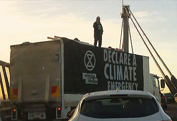 Extinction Rebellion protestors atop rented truck on West Gate Bridge (Nine)