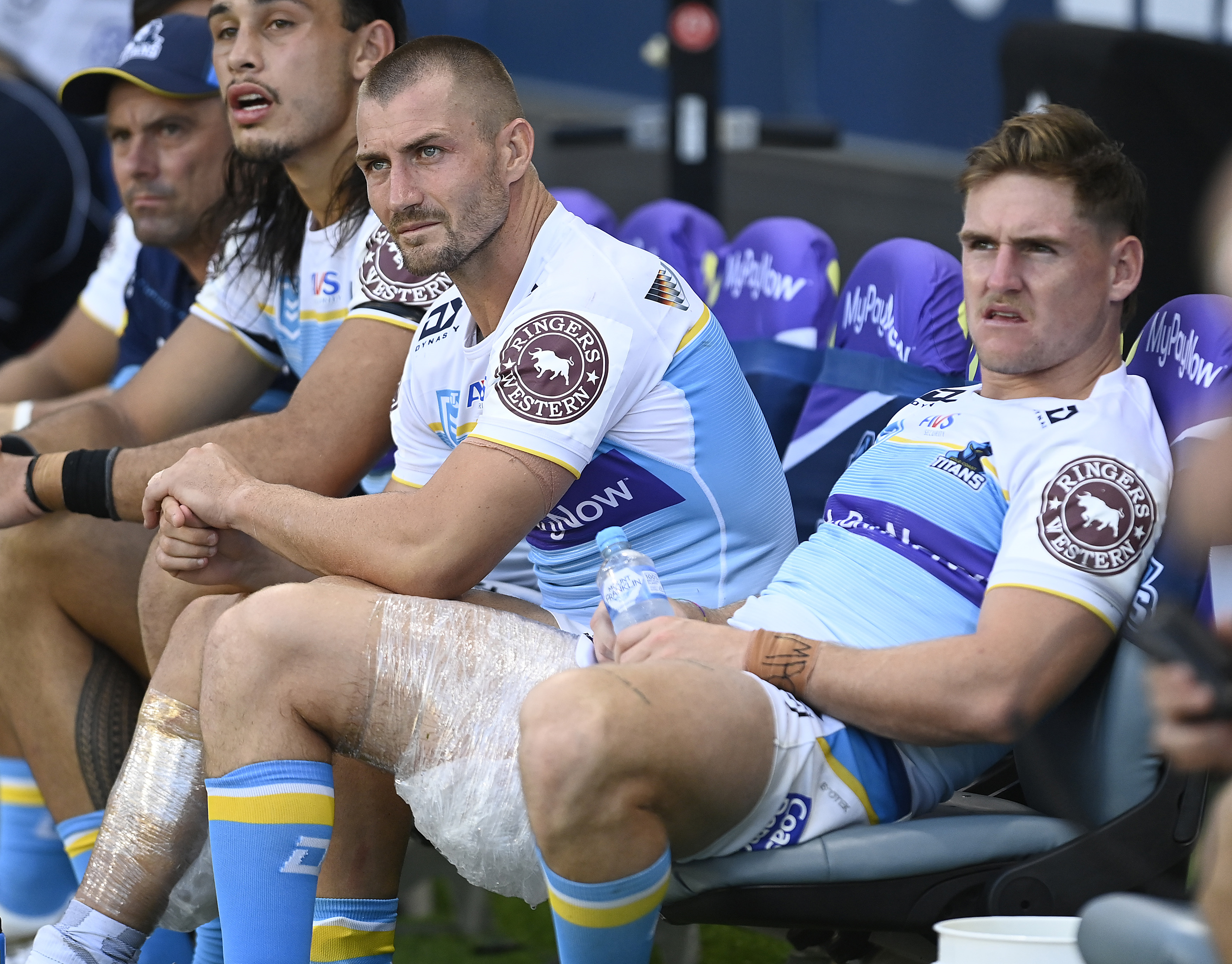 AJ Brimson and Kieran Foran sit on the bench after being injured during the round four NRL match between North Queensland Cowboys and Gold Coast Titans.