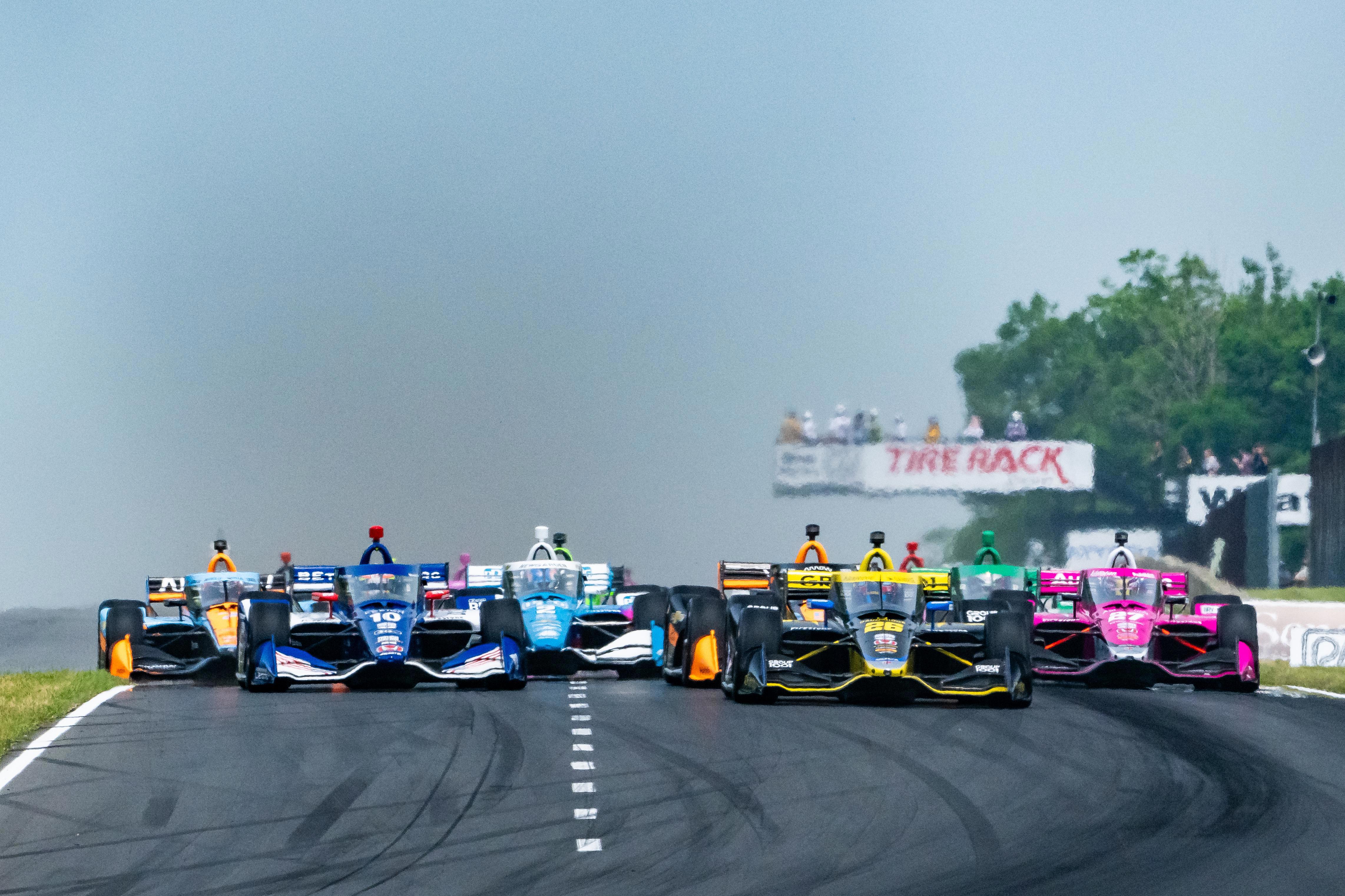 Colton Herta leads the field into turn one at Road America.