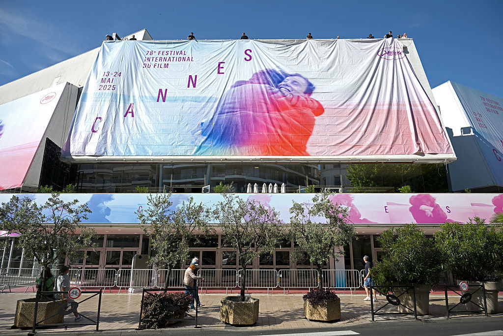 CANNES, FRANCE - MAY 11: Workers install the official festival poster at the Palais de Festival ahead of the 78th annual Cannes Film Festival at on May 11, 2025 in Cannes, France. (Photo by Thomas Kronsteiner/Getty Images)