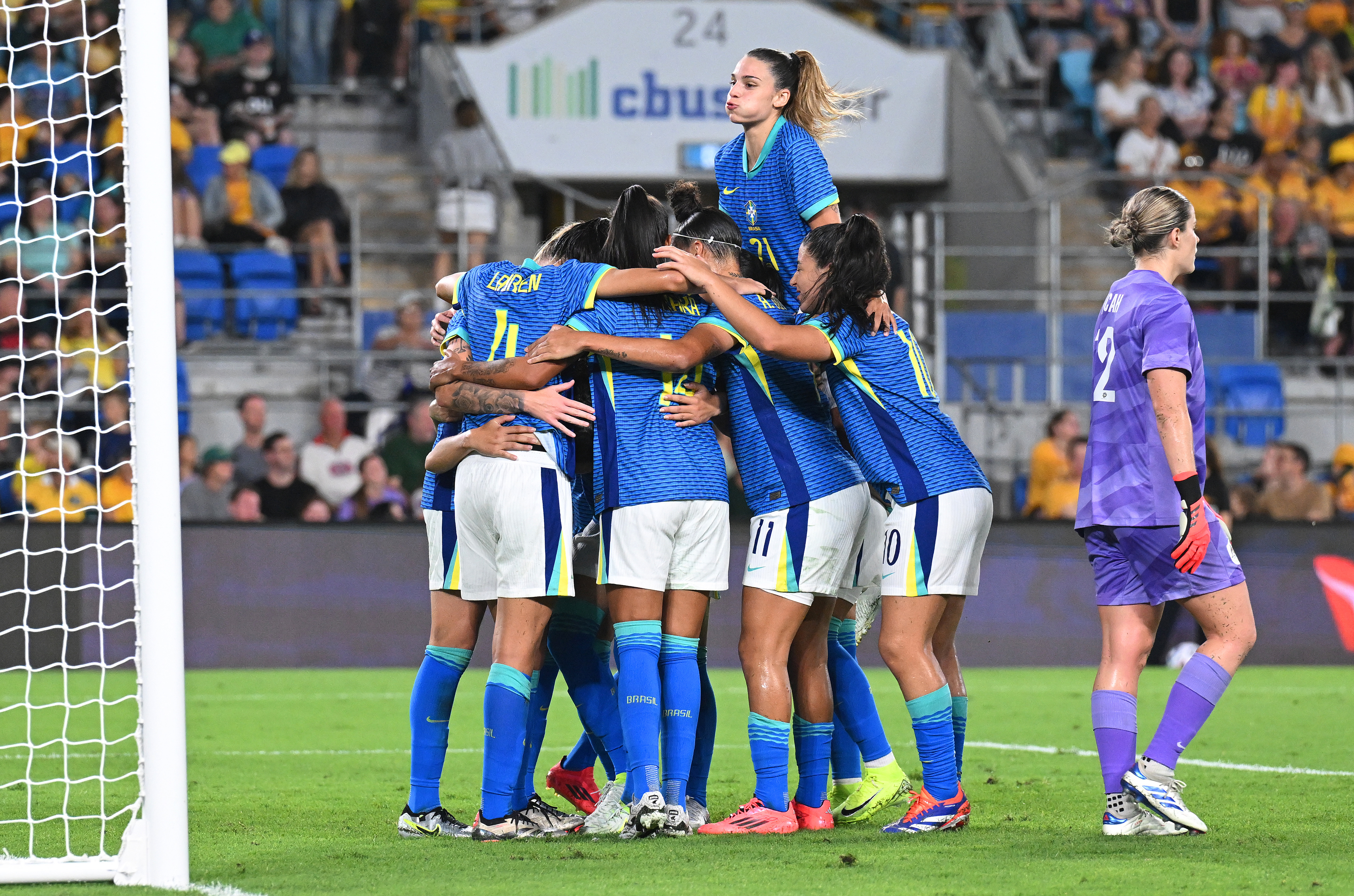 Lauren of Brazil celebrates with teammates after scoring her team's second goal against Australia.