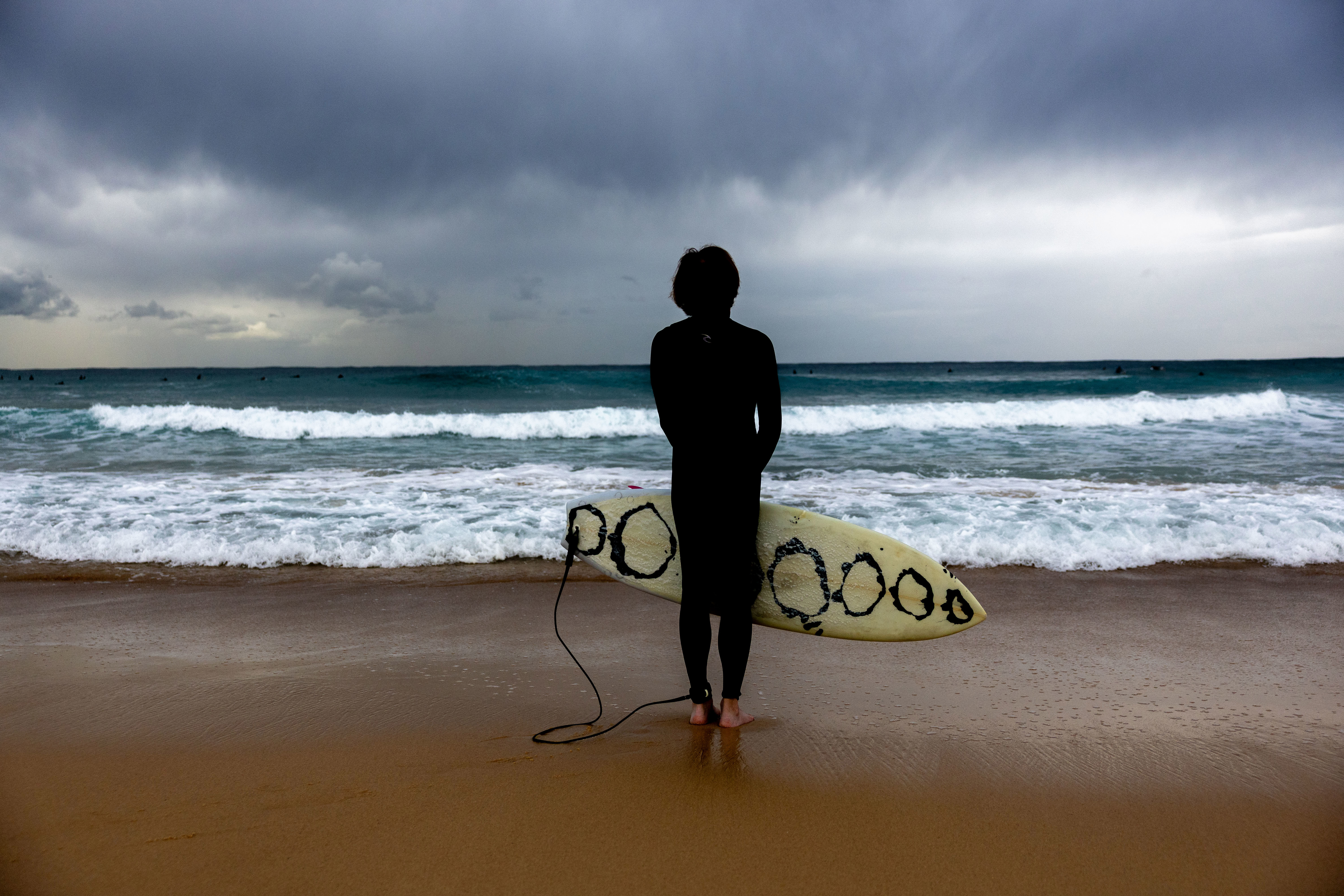 A surfer gauges current conditions at Maroubra beach, ahead of an increased swell in Sydney, Friday, 27 March 2026.