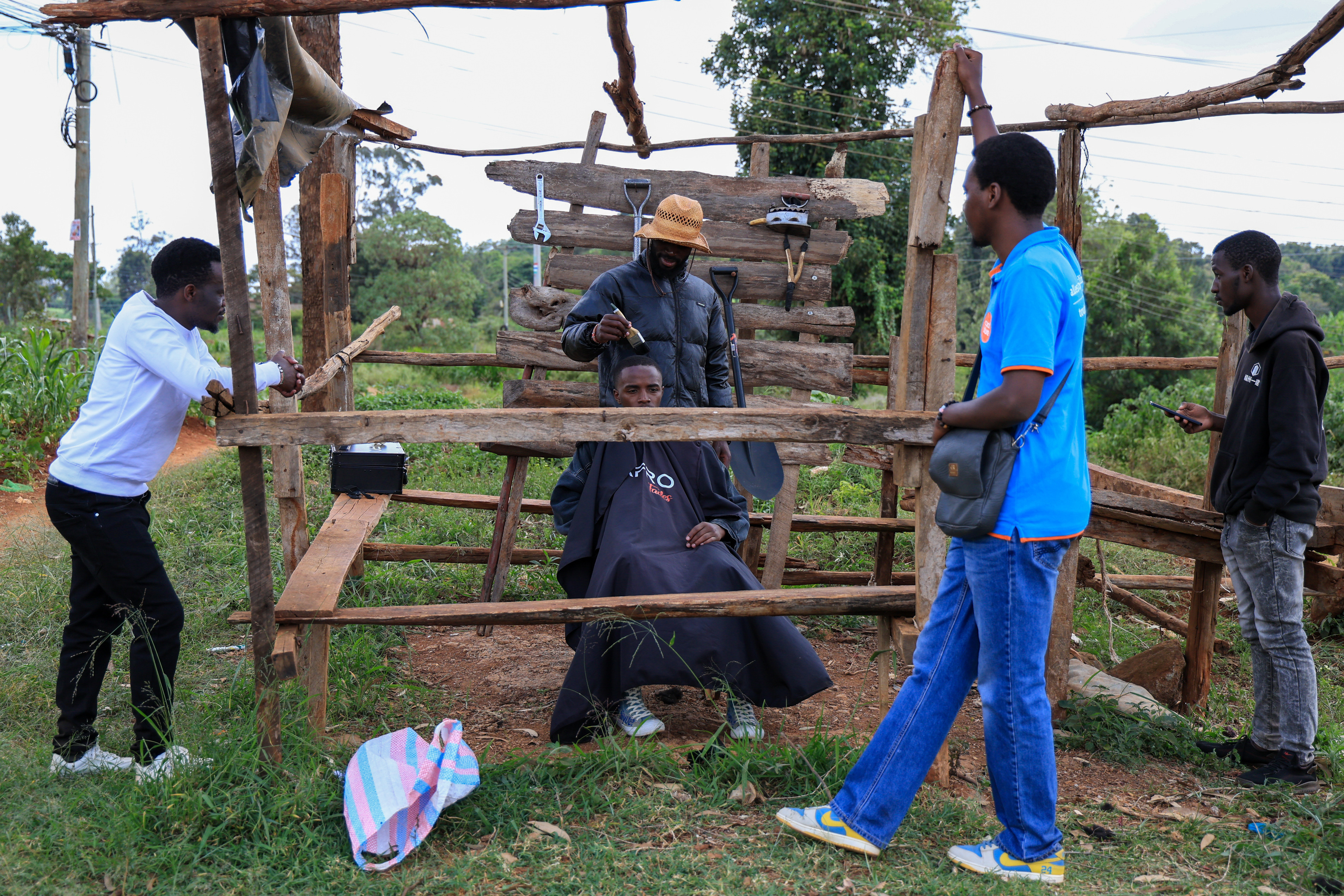 Barber and content creator Safari Martins shaves Ian Njenga in Kiambu, Kenya on Wednesday, November 26.