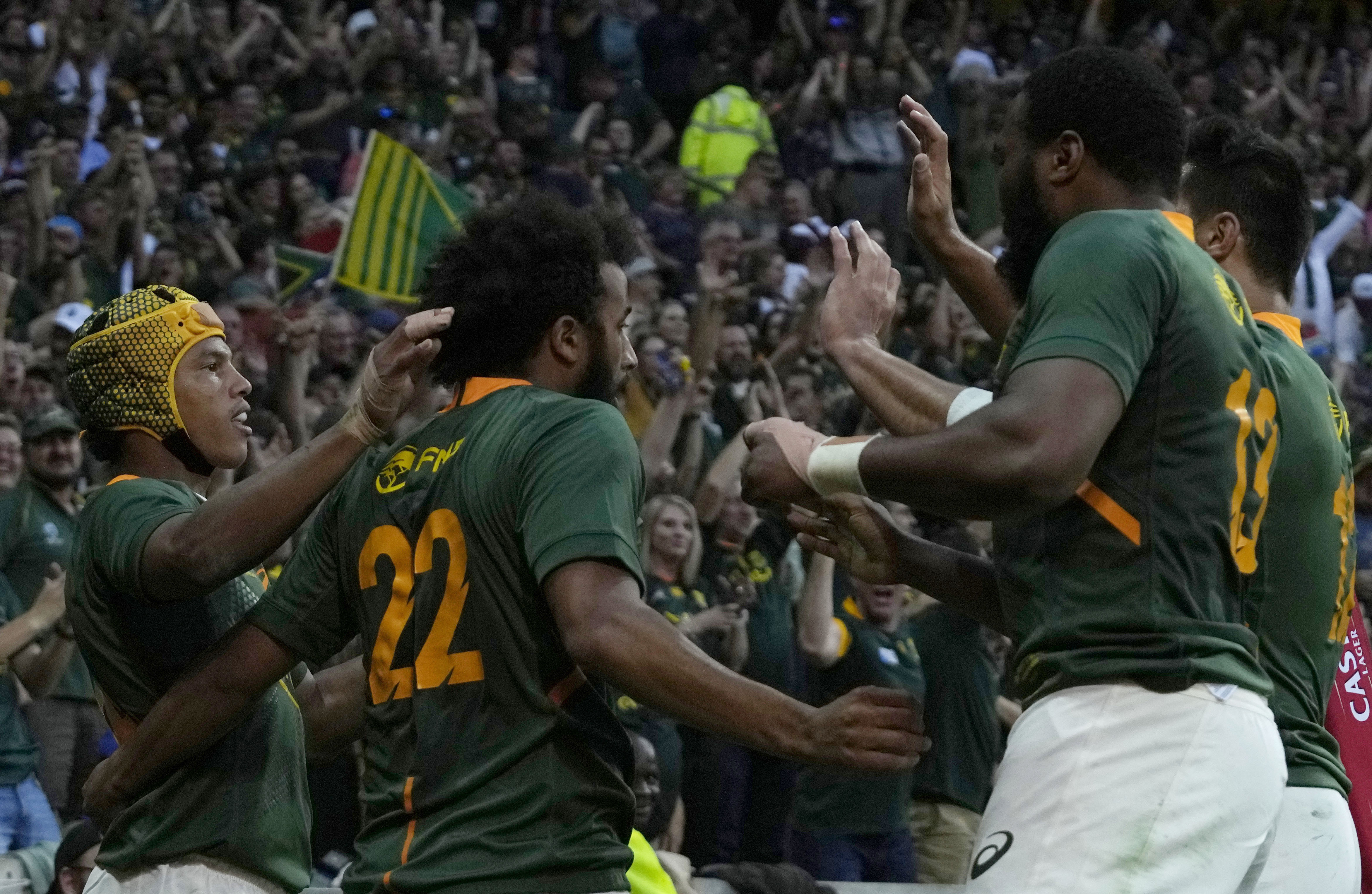 South Africa's Kurt-Lee Arendse celebrates with teammates after scoring a try.