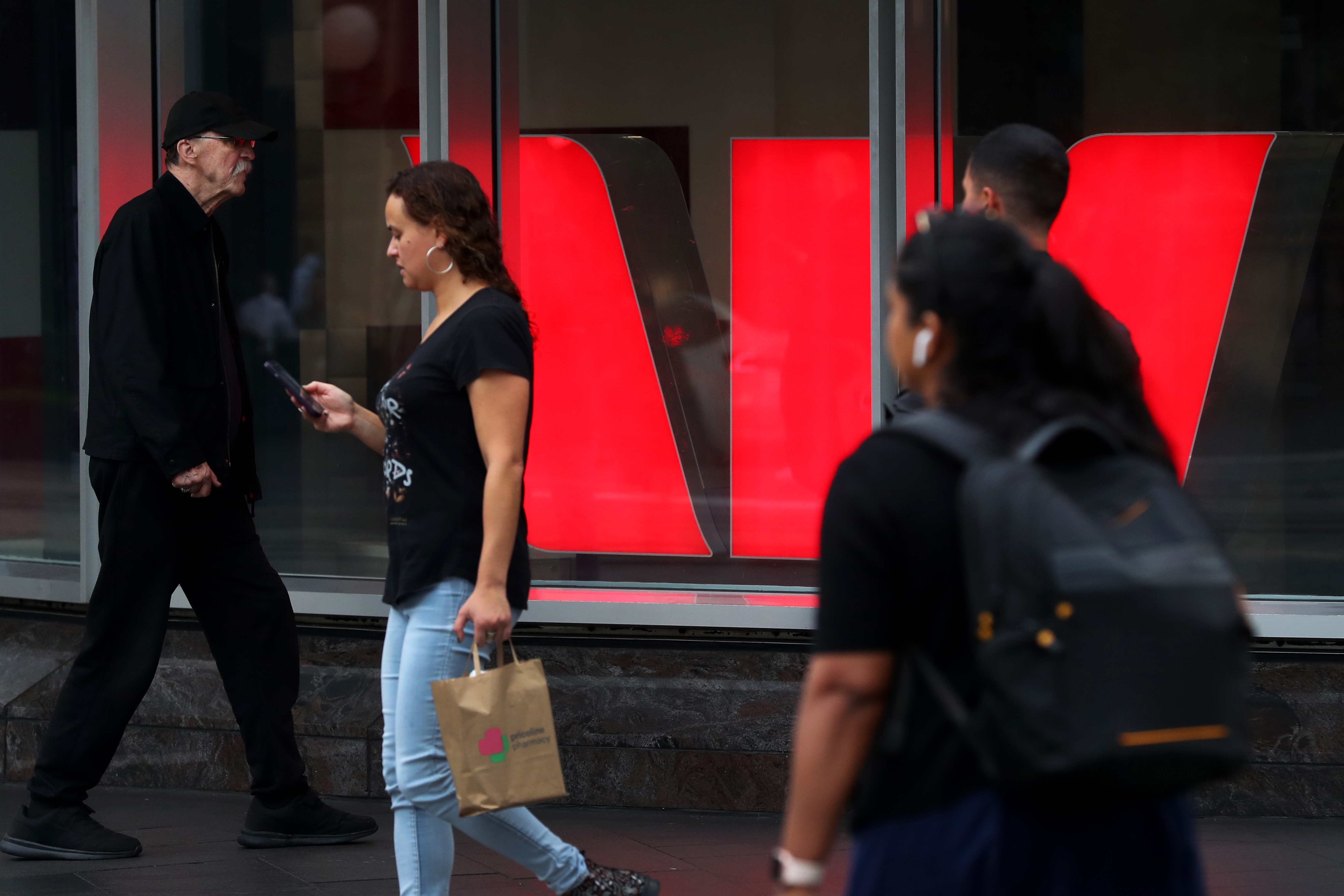 Pedestrians move past a Westpac Bank in the central business district (CBD) on March 26, 2025 in Sydney, Australia.
