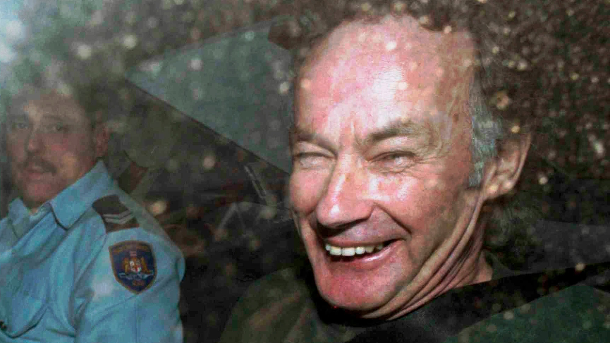 In this Nov. 4, 1997, file photo, Ivan Milat smiles in a police car after attending a court in Sydney.