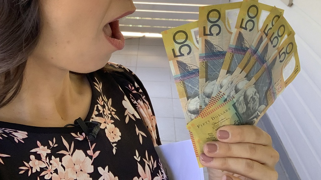 Woman holding cash money.