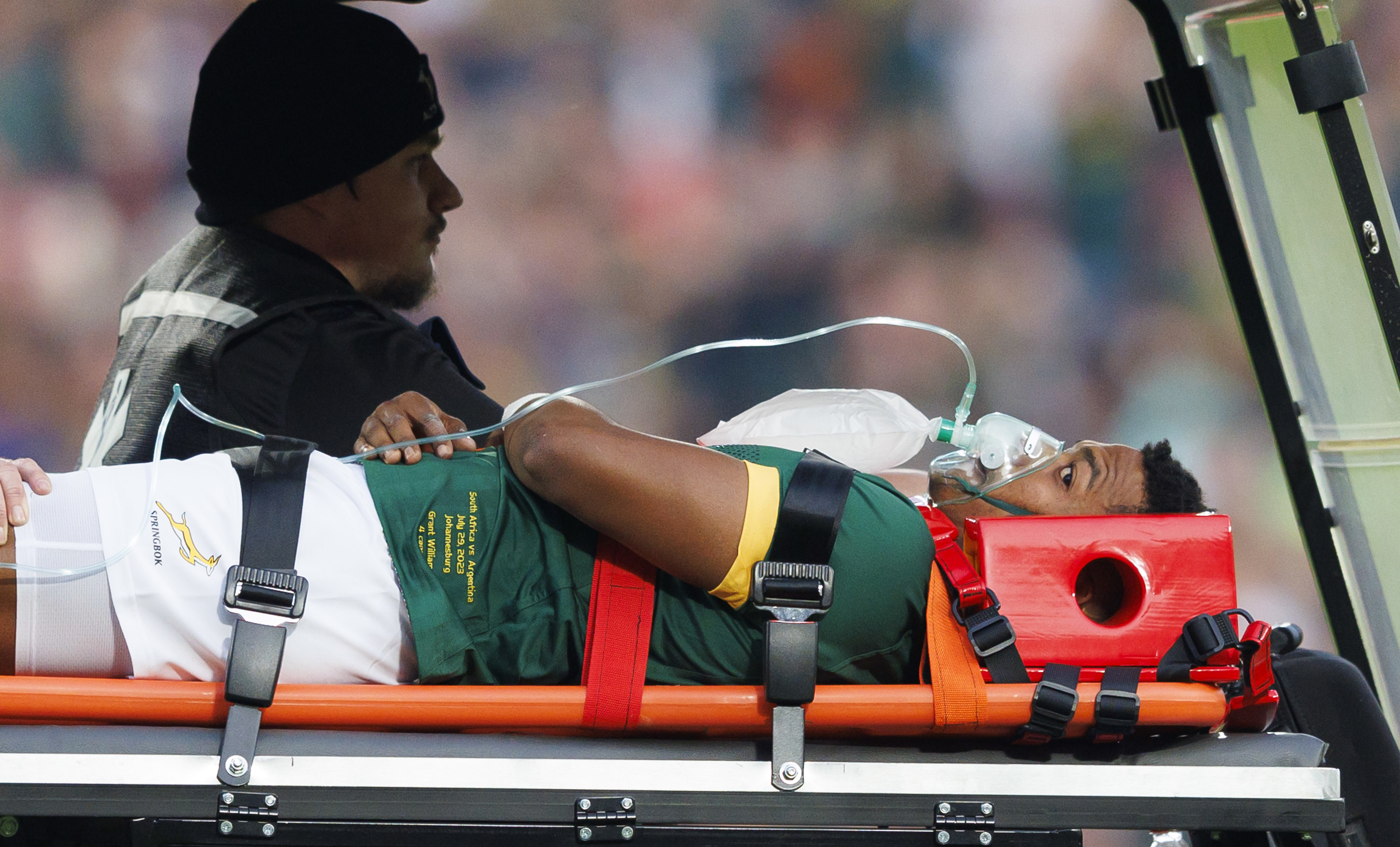 Springboks debutant Grant Williams is carted off after taking a hip to the head. 