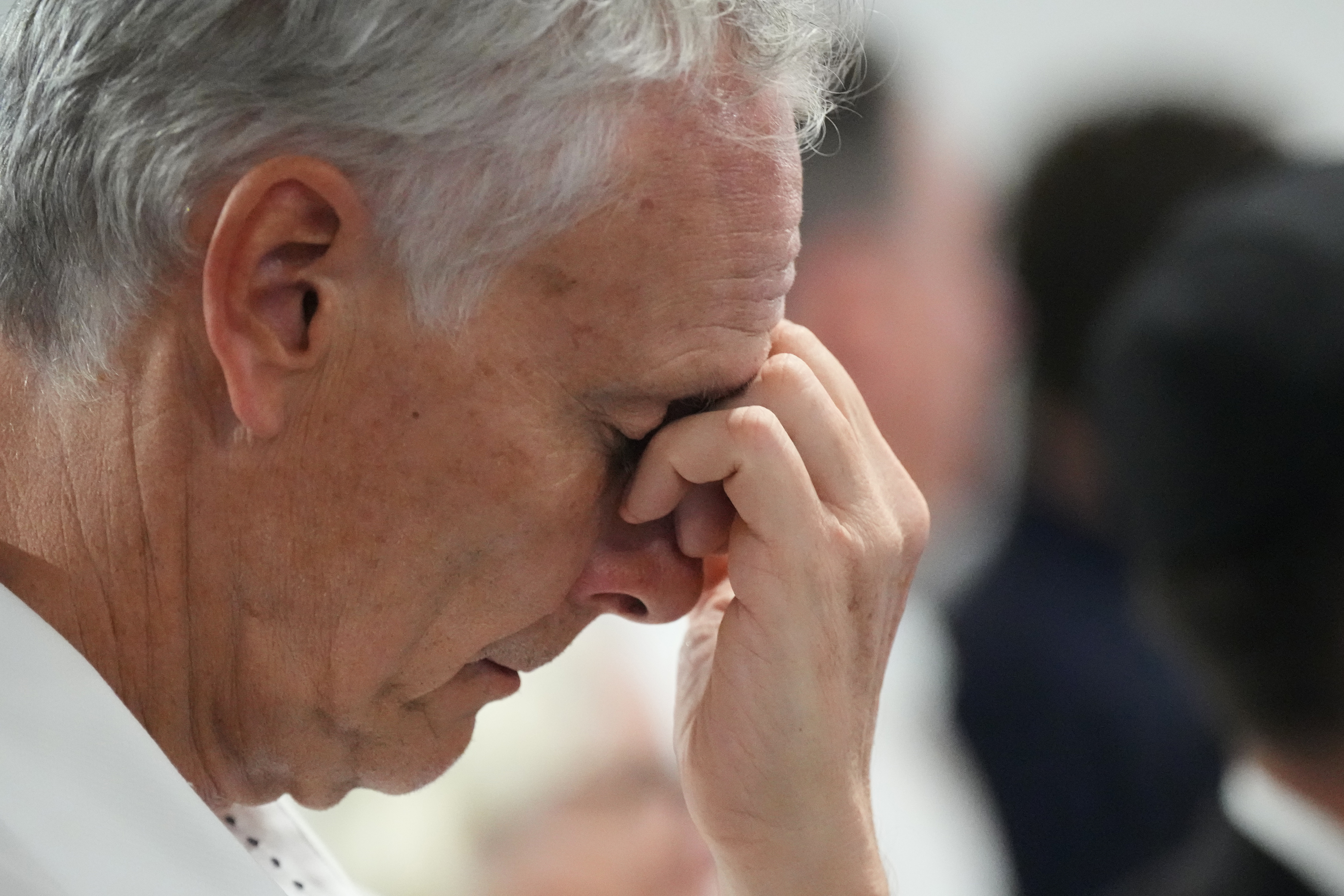 A mourner reacts at a synagogue during the funeral of Rabbi Eli Schlanger, a victim in the Bondi Beach mass shooting, in Bondi on Wednesday, Dec. 17, 2025, in Sydney, Australia. (AP Photo/Mark Baker, Pool)