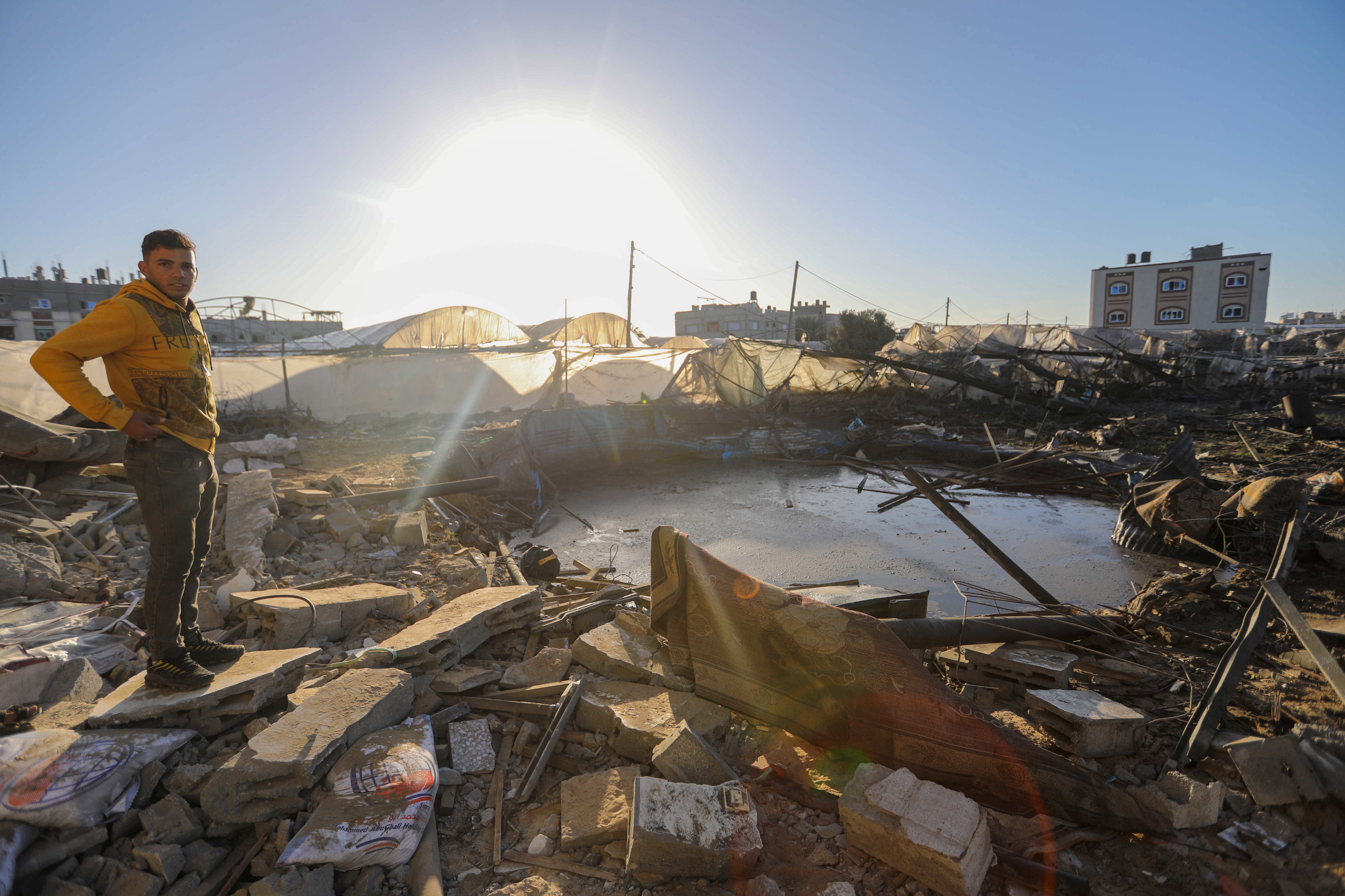 People inspect damage and recover items from their homes following Israeli air strikes on March 15, 2024 in Rafah, Gaza. 