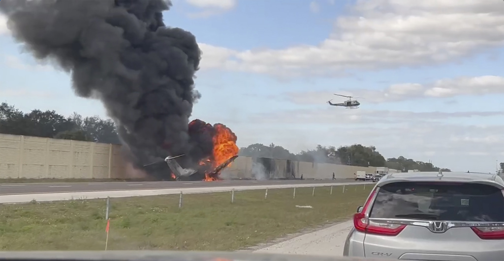 Smoke and fire fills the air after an airplane crashed on Interstate 75, Friday, Feb. 10, 2024 near Naples, Fla. 