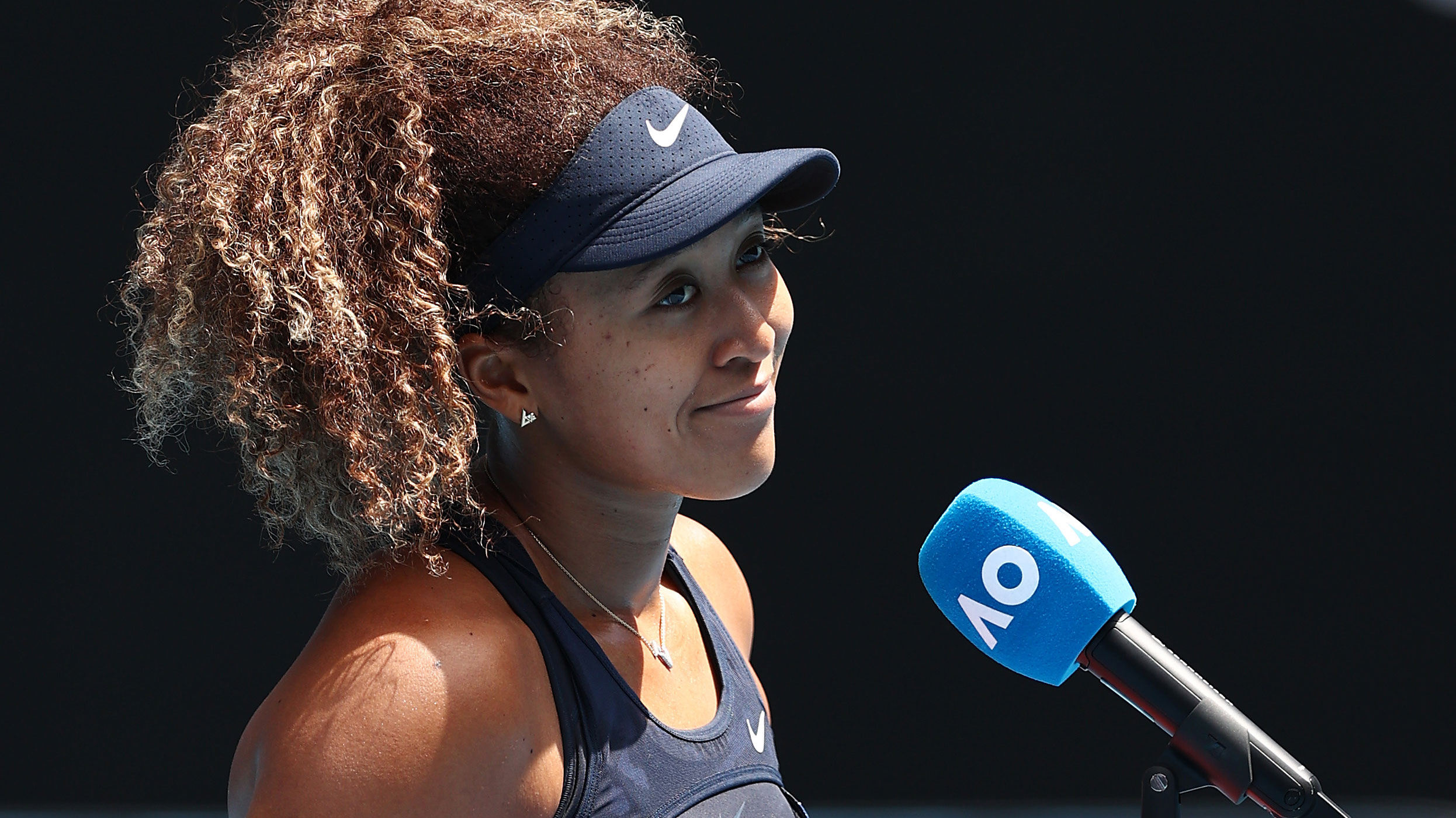 Naomi Osaka is interviewed after winning her Australian Open quarter-final.