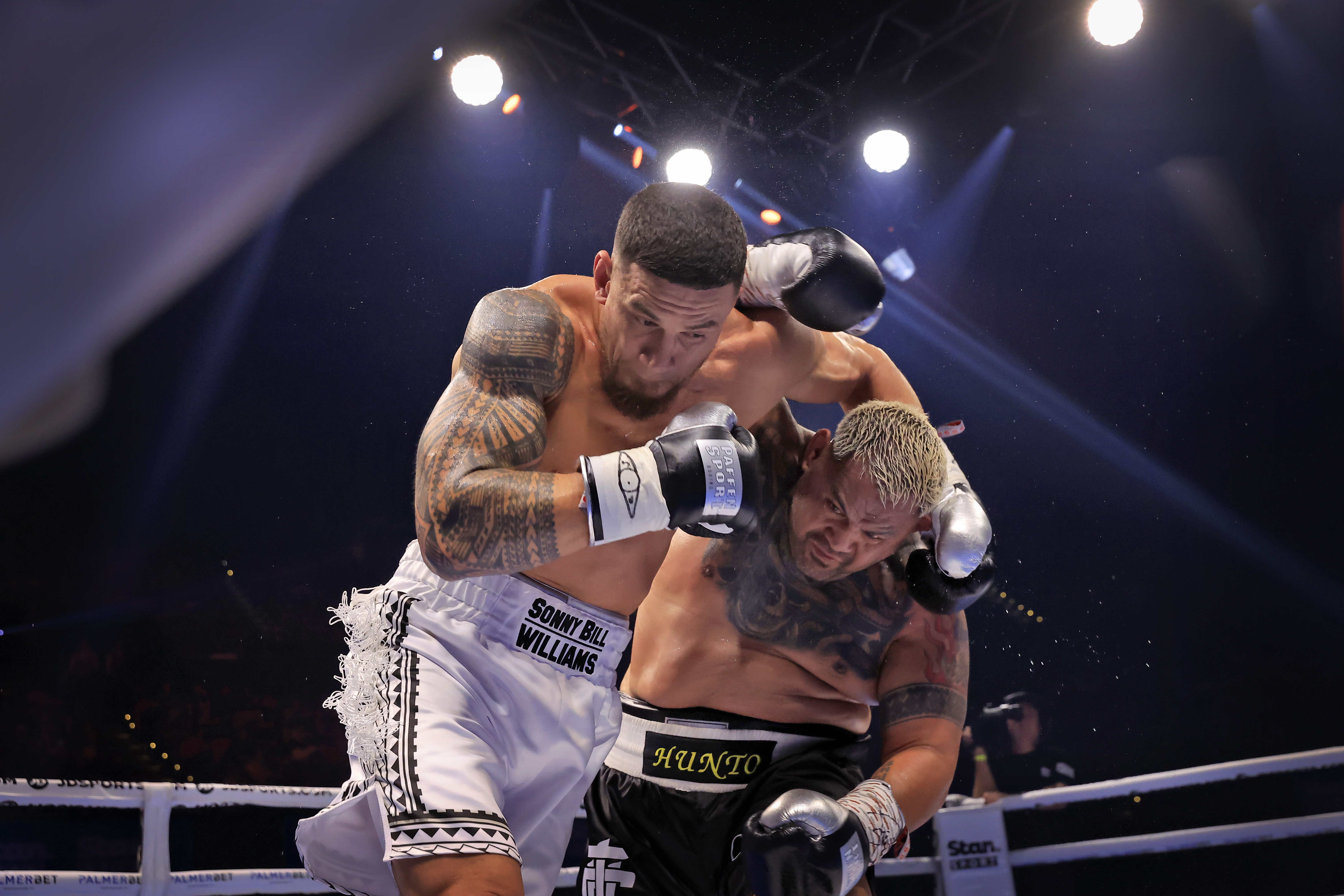 Sonny Bill Williams and Mark Hunt trade punches during the heavyweight fight in Sydney.