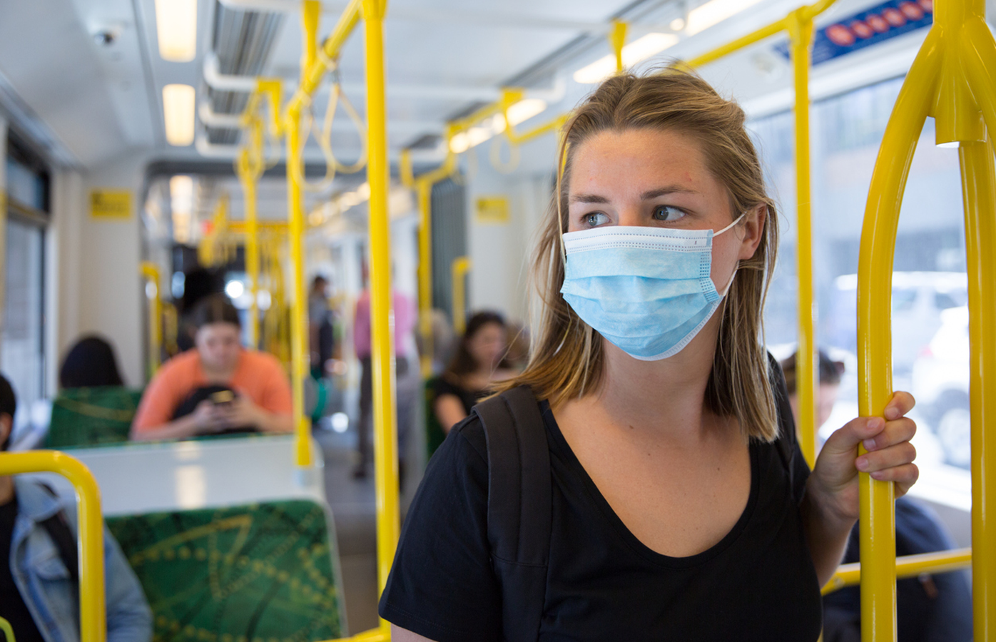 Woman wears face mask on public transport