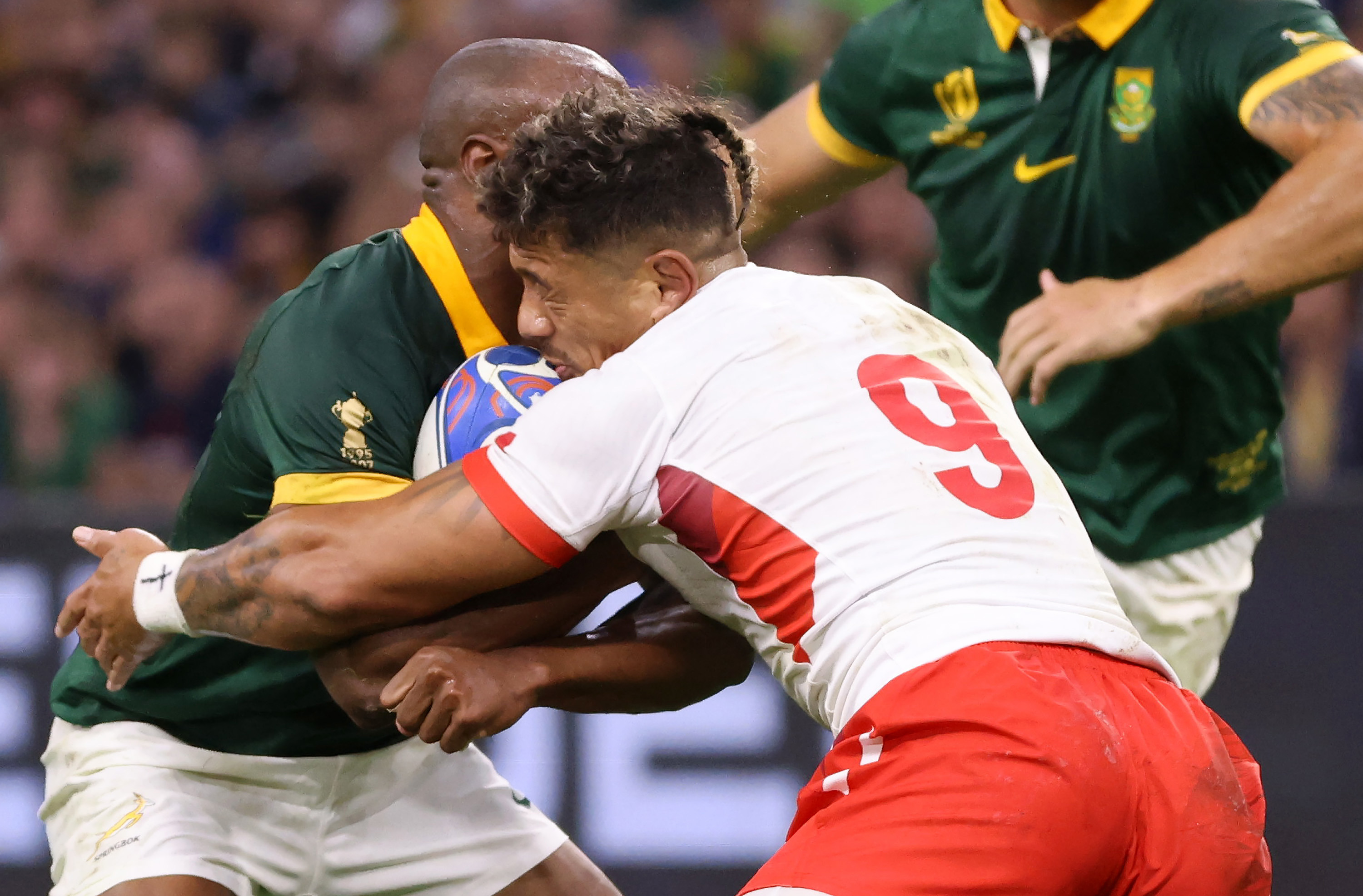 Augustine Pulu of Tonga clashes heads with Makazole Mapimpi of South Africa.