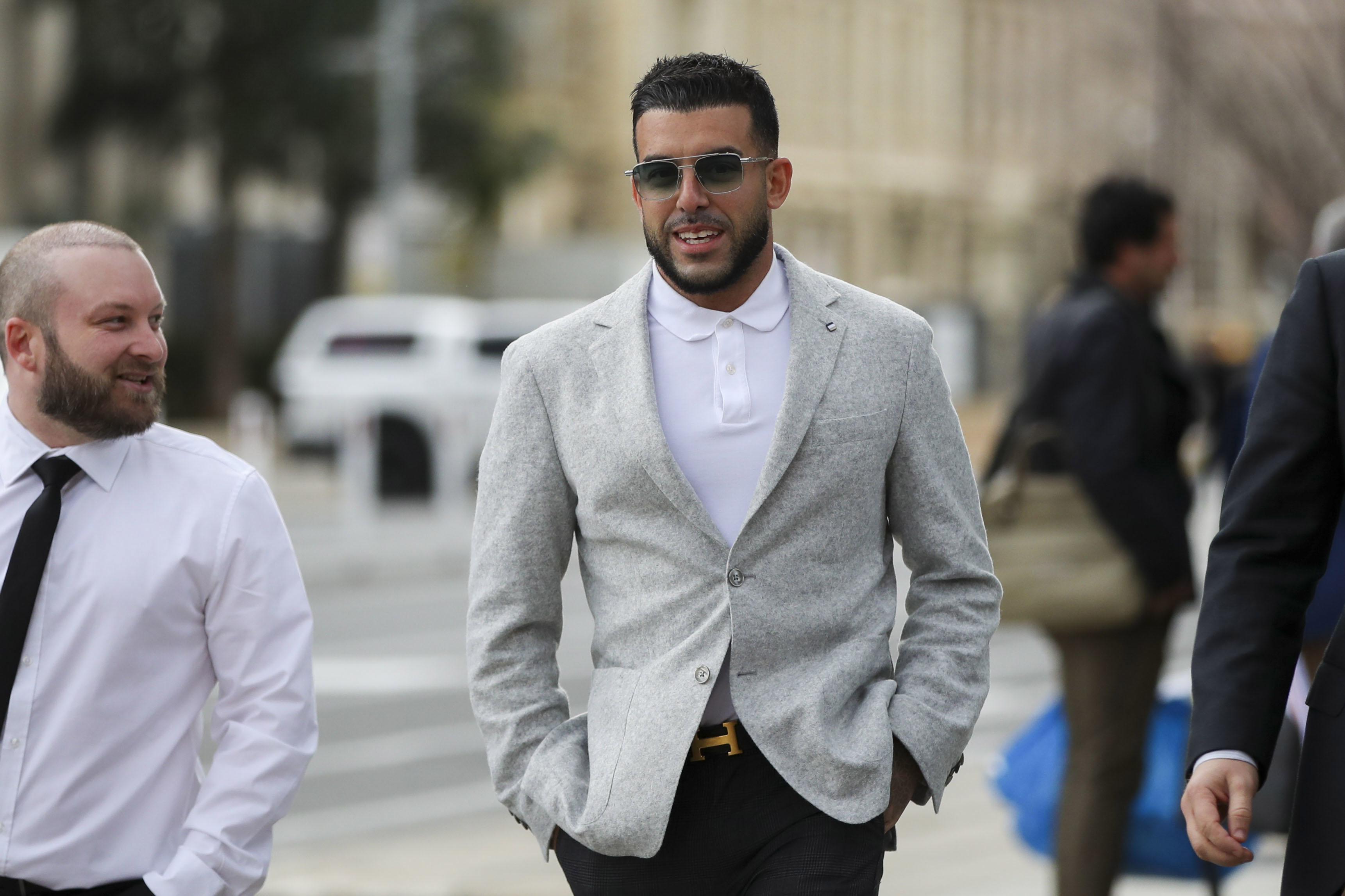 Businessman Adrian Portelli (centre) arrives at the Adelaide Magistrates Court, in Adelaide, Friday, September 5, 2025. 