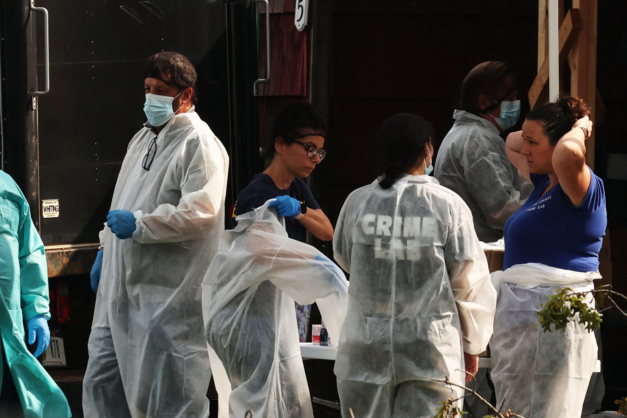 Crime scene investigators are pictured at the residence of architect Rex A. Heuermann, who was arrested a suspect in connection with serial killings more than a decade ago, that targeted sex workers and others, whose bodies were strewn along Gilgo beach, in Massapequa Park, New York, U.S., July 18, 2023. 