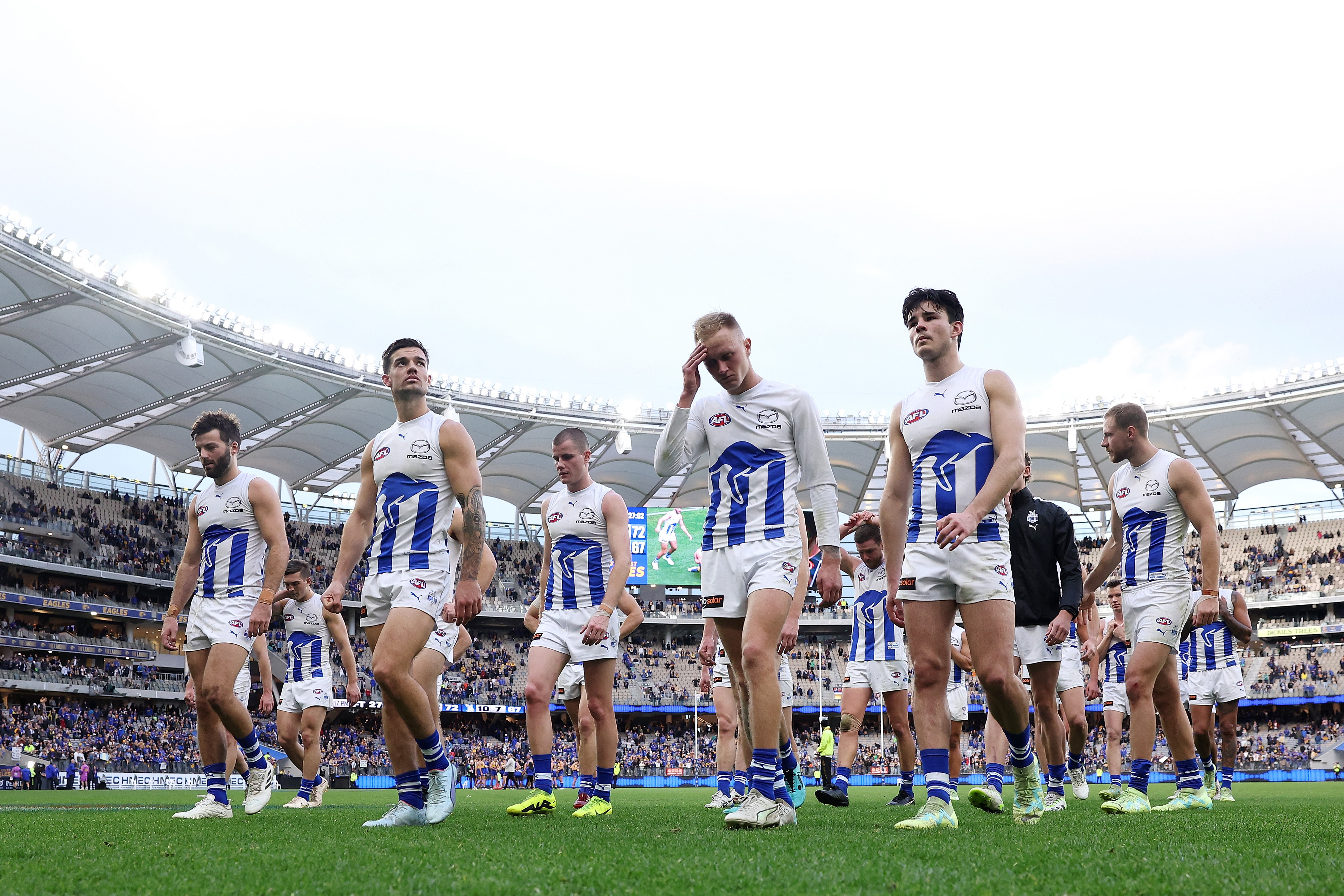 PERTH, AUSTRALIA - JULY 30: The Kangaroos leave the field after the teams defeat during the 2023 AFL Round 20 match between the West Coast Eagles and the North Melbourne Kangaroos at Optus Stadium on July 30, 2023 in Perth, Australia. (Photo by Will Russell/AFL Photos via Getty Images)