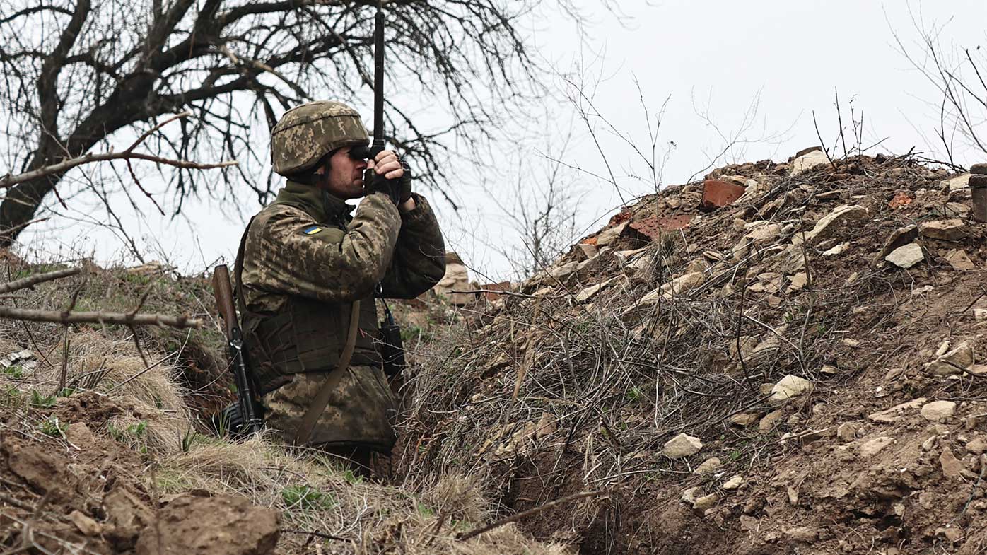 A Ukrainian soldier watches through a periscope at fighting positions on the line of separation from pro-Russian rebels near Donetsk.