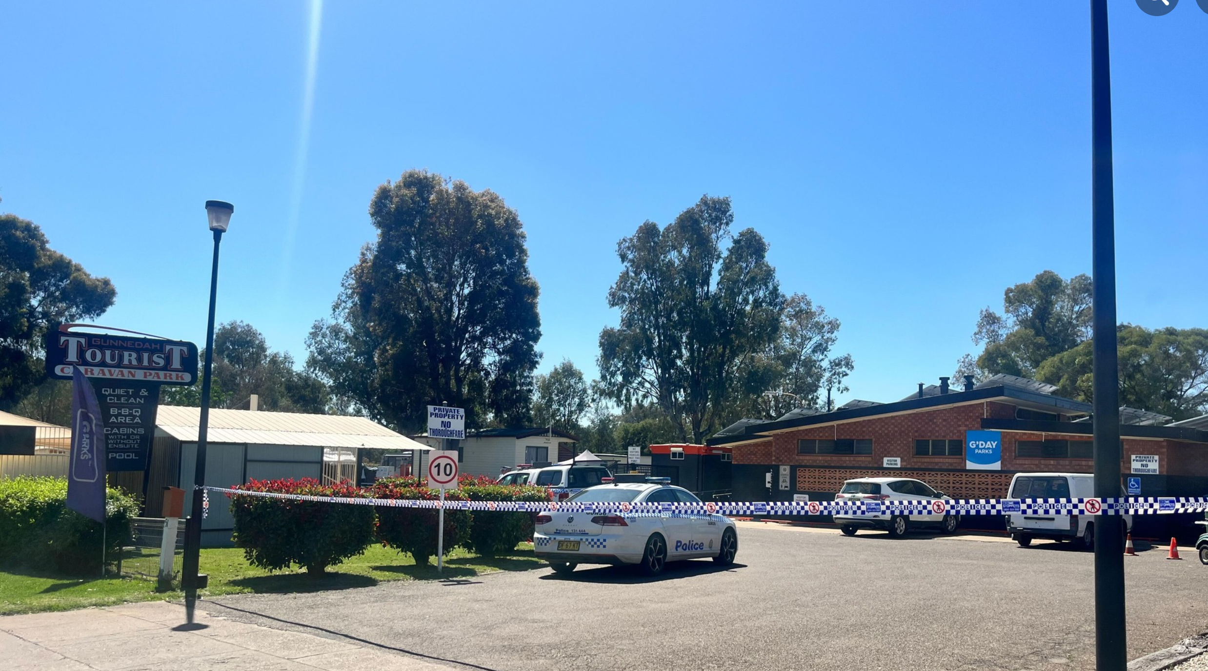 A caravan park in a rural NSW town has become a crime scene after a woman's body was found and a man was arrested.